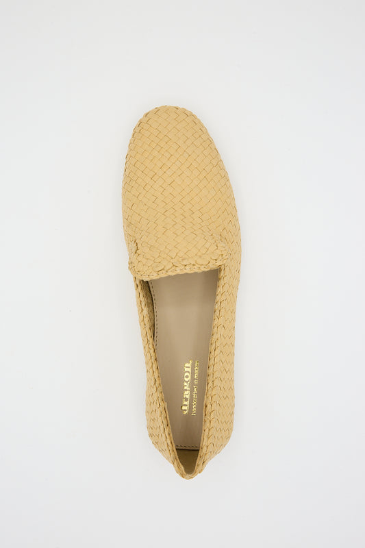 Handwoven goatskin leather Damas Slipper in Natural by Dragon Diffusion on a white background. Overhead view.