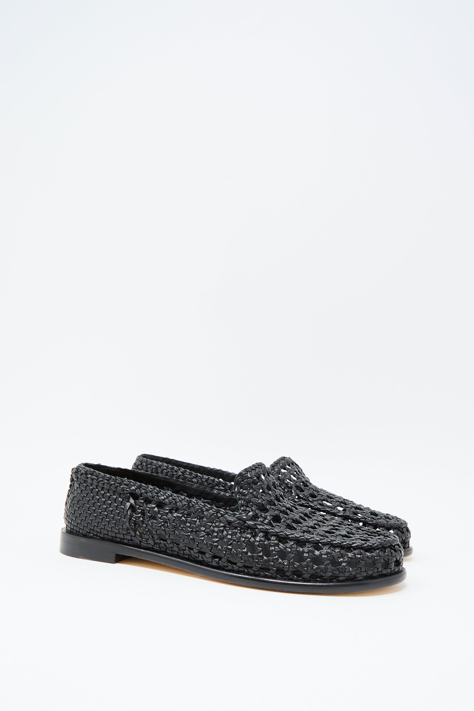 The Dragon Diffusion Dolly Moccasin in Black features woven leather and flat soles, showcased against a plain white background.