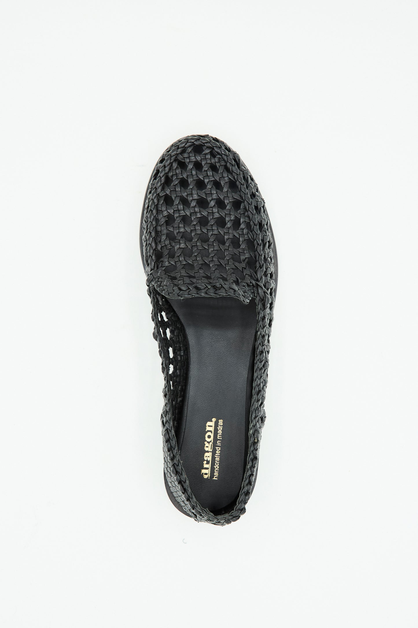 The Dolly Moccasin in Black by Dragon Diffusion is a black woven leather slip-on shoe, shown from above to highlight its insole with gold branding.