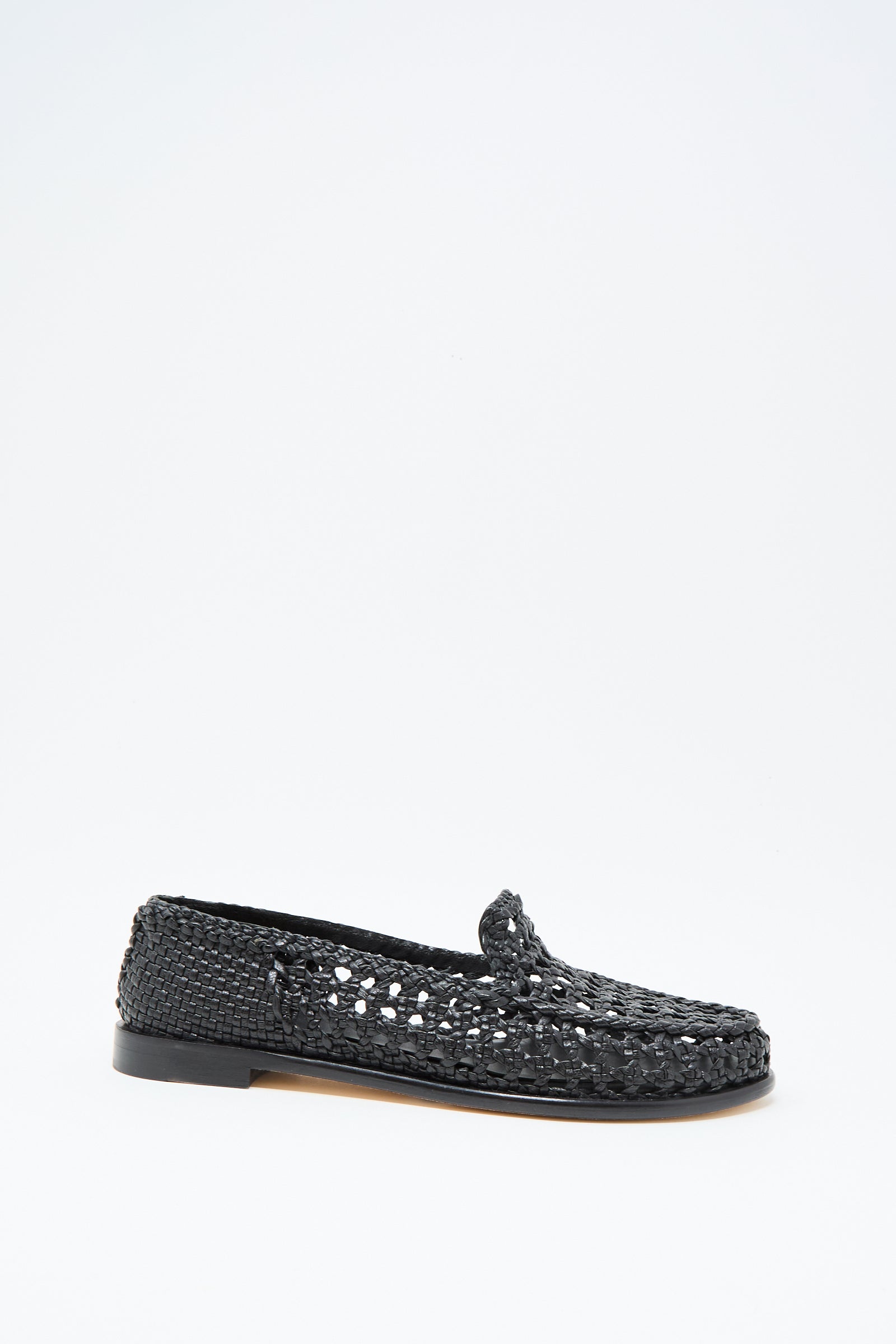 The Dolly Moccasin in Black by Dragon Diffusion is a black woven leather loafer with a low heel and closed toe, shown on a plain white background.