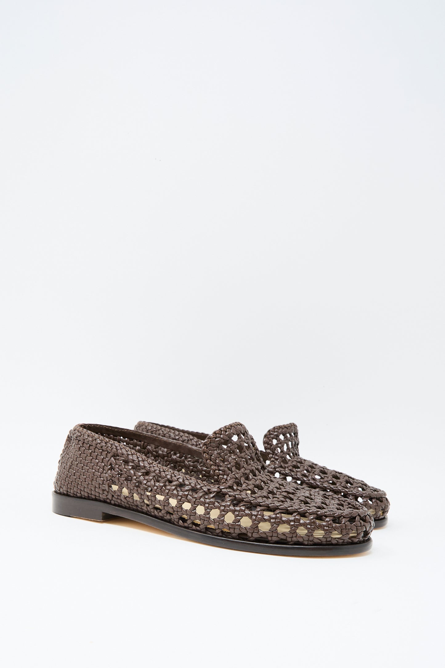 The Dragon Diffusion Dolly Moccasin in Dark Brown features woven leather, flat black soles, and an almond toe, shown against a plain white background.