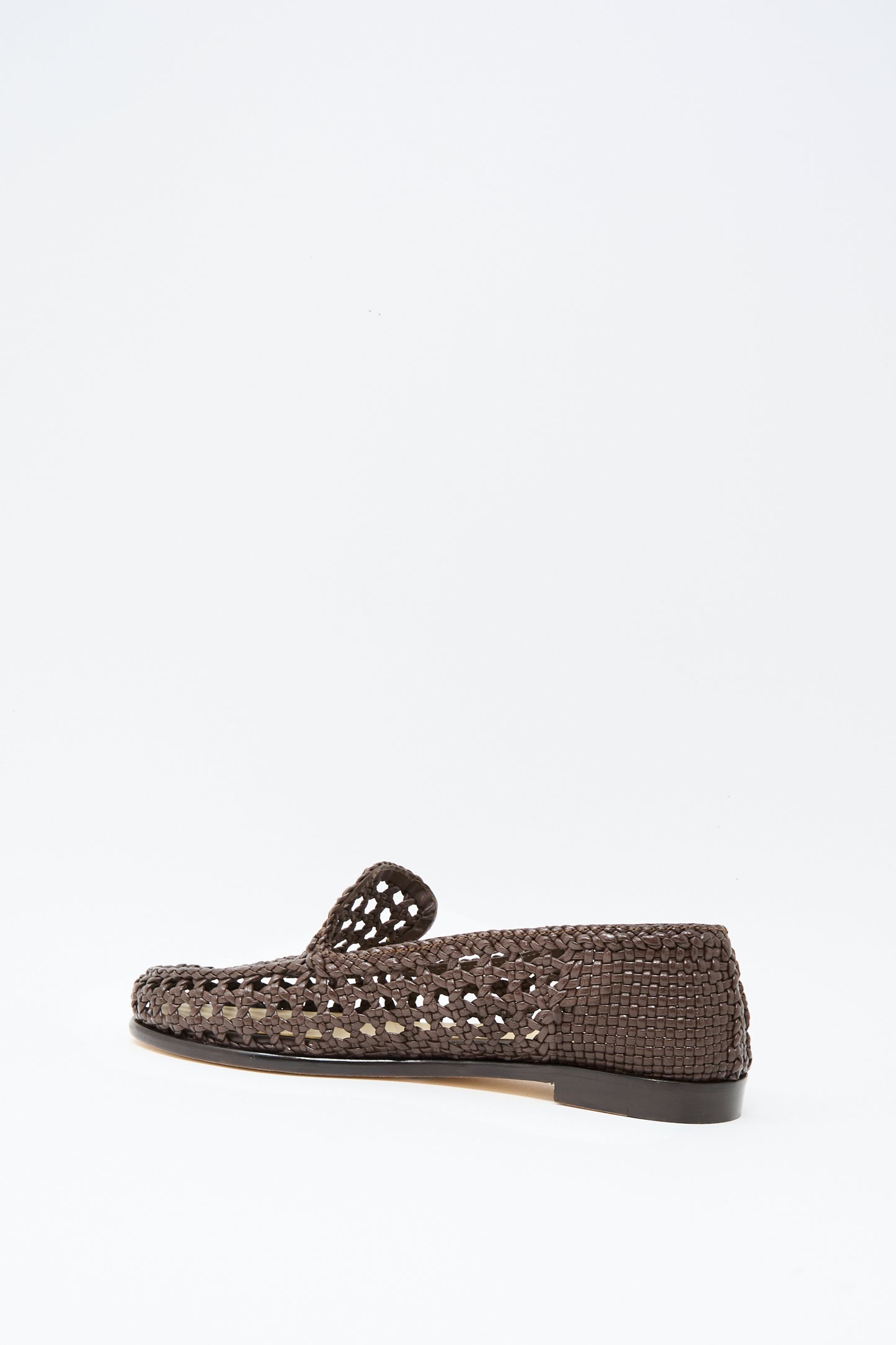The Dolly Moccasin in Dark Brown by Dragon Diffusion, featuring woven leather, an almond toe, and a flat heel, is shown in profile against a plain white background.