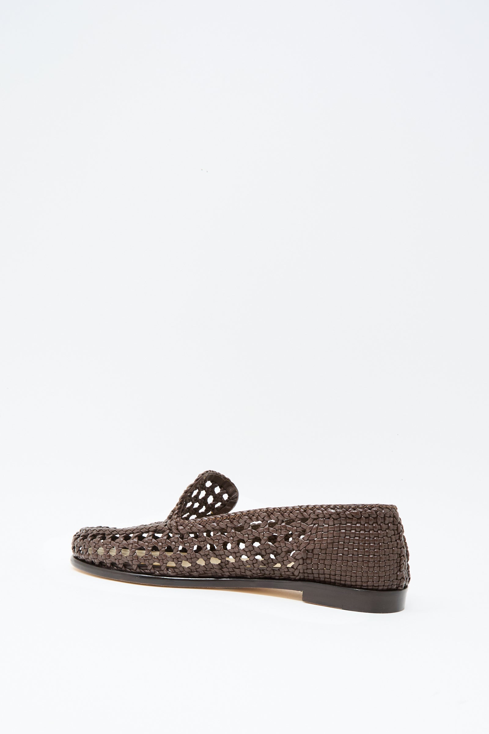The Dolly Moccasin in Dark Brown by Dragon Diffusion, featuring woven leather, an almond toe, and a flat heel, is shown in profile against a plain white background.