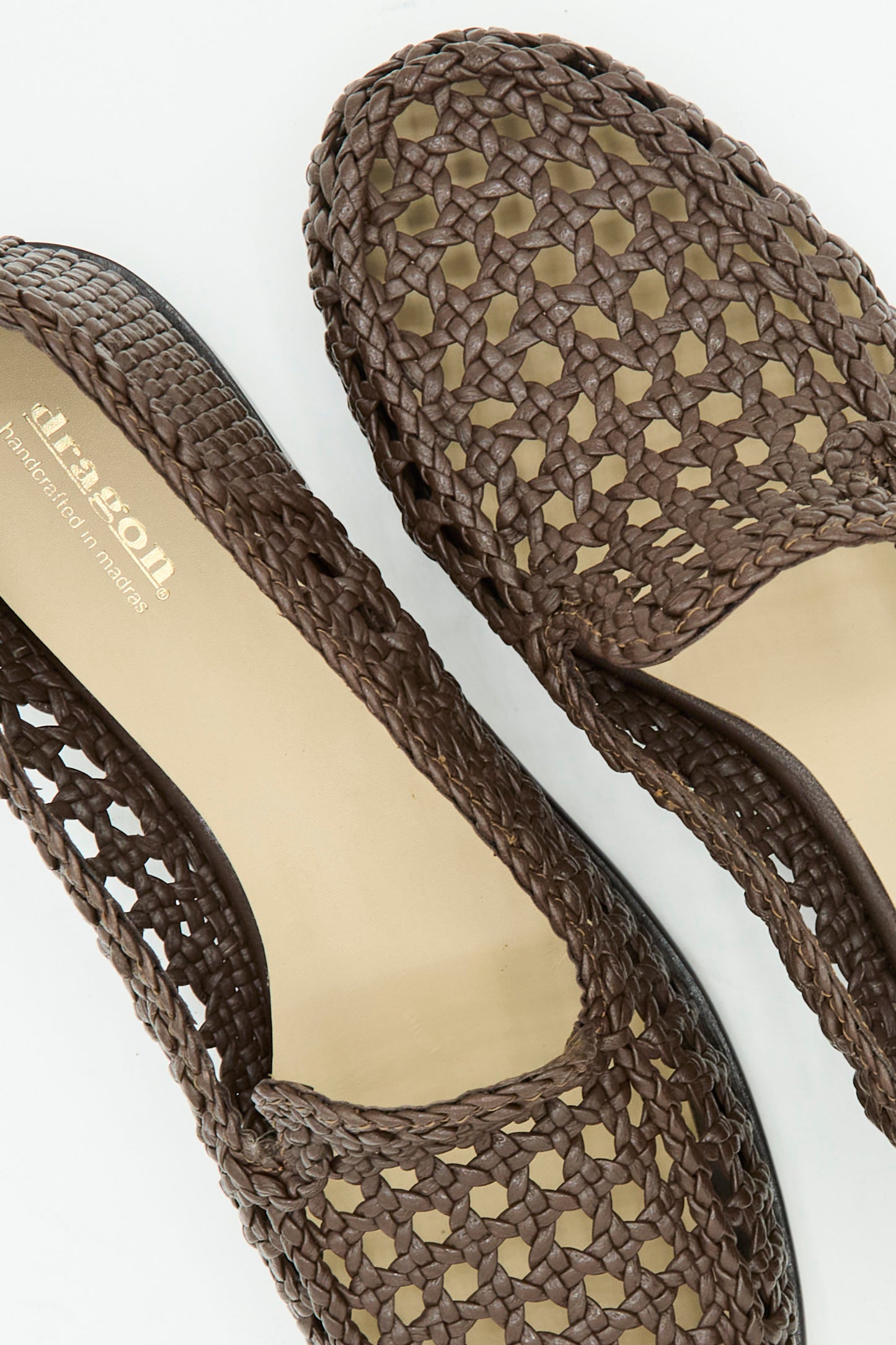 Close-up of Dragon Diffusion's Dolly Moccasin in Dark Brown, featuring a woven leather design, almond toe, and beige insoles, displayed on a white background.