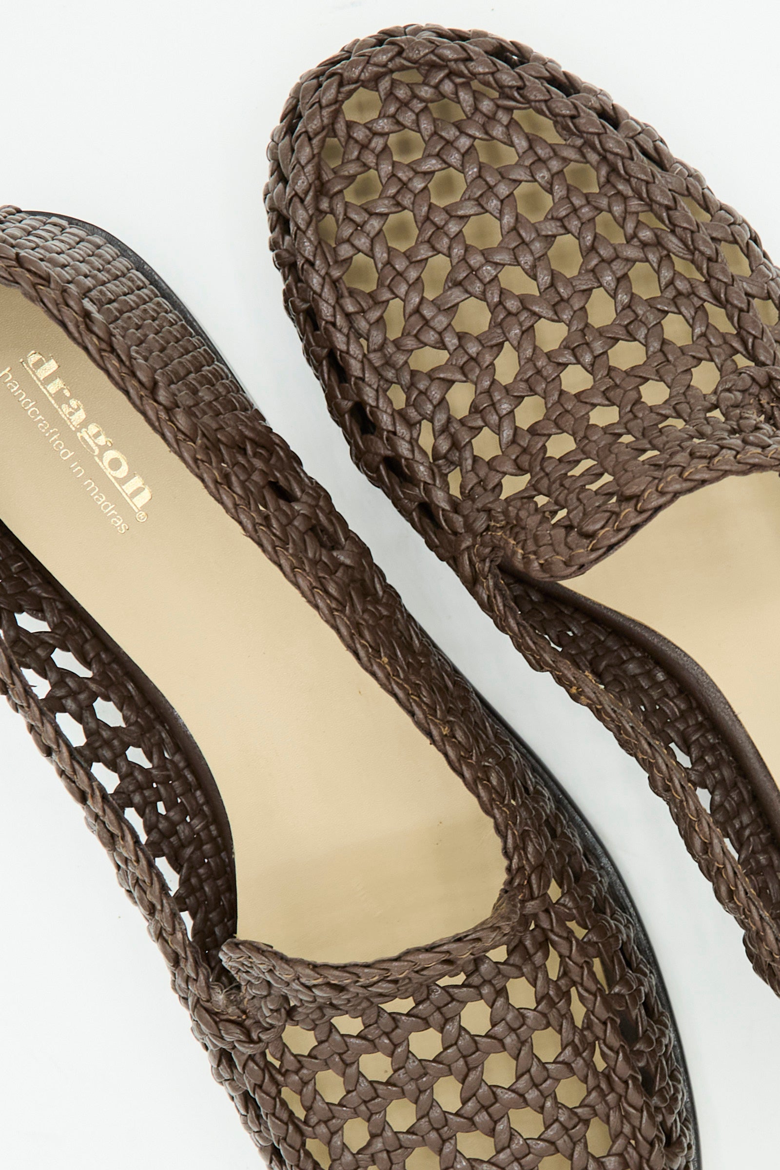 Close-up of Dragon Diffusion's Dolly Moccasin in Dark Brown, featuring a woven leather design, almond toe, and beige insoles, displayed on a white background.