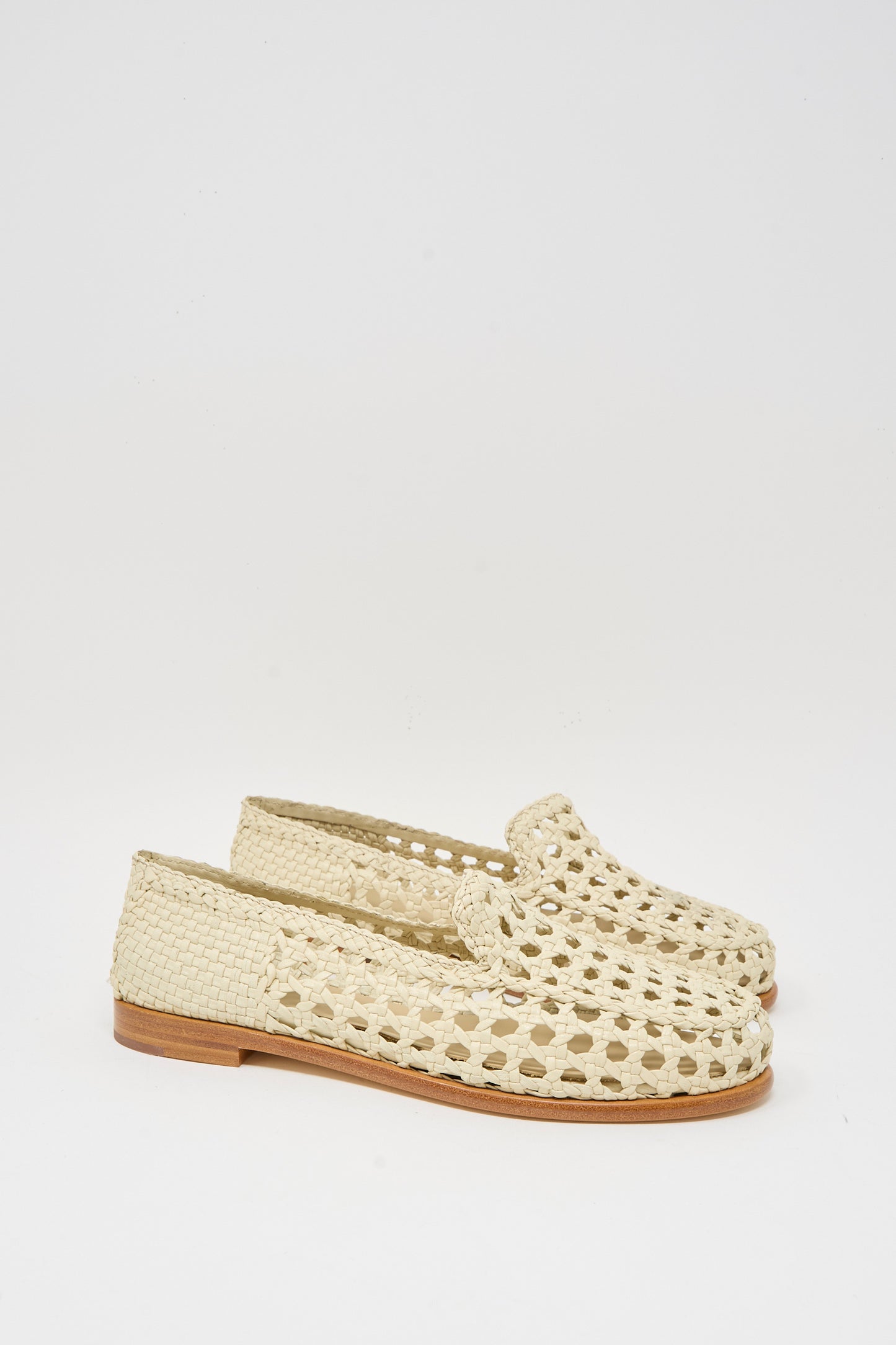 The Dragon Diffusion Dolly Moccasin in Off White features woven goat leather, a cut-out design, and flat wooden soles, shown against a plain white background.
