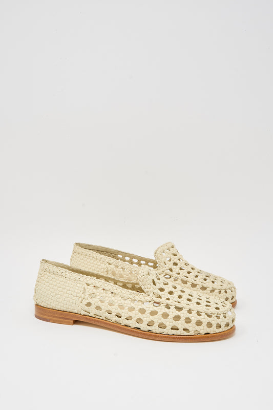 The Dragon Diffusion Dolly Moccasin in Off White features woven goat leather, a cut-out design, and flat wooden soles, shown against a plain white background.