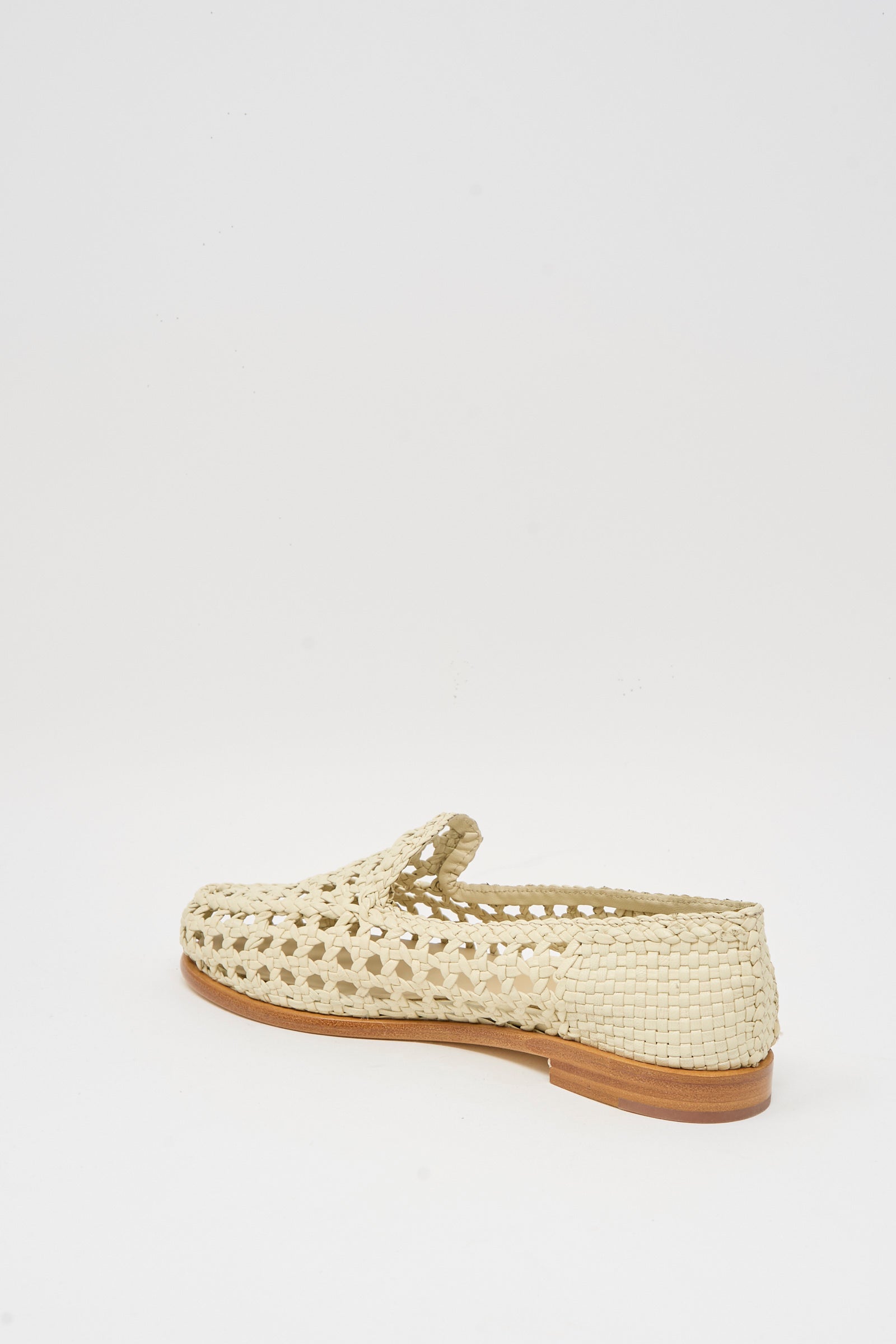 The Dragon Diffusion Dolly Moccasin in Off White is a goat leather slip-on with woven detailing and a low brown sole, displayed at an angle on a plain white background.