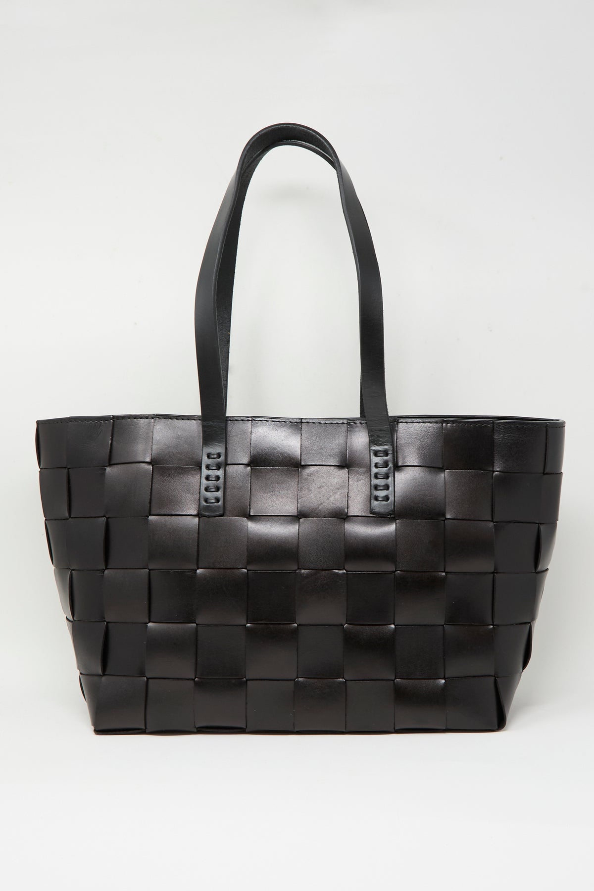 The Dragon Diffusion Japan Tote in Black is a large, basket-shaped tote bag crafted from cross-woven leather, featuring two shoulder straps and displayed against a plain white background.