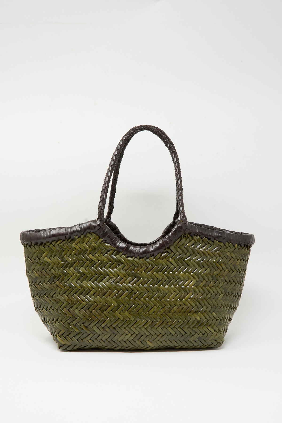 The Nantucket Small Bi-Color bag by Dragon Diffusion, crafted from handwoven calf leather in dark brown and khaki, features two dark woven handles and is displayed on a plain white background in a classic basket shape.