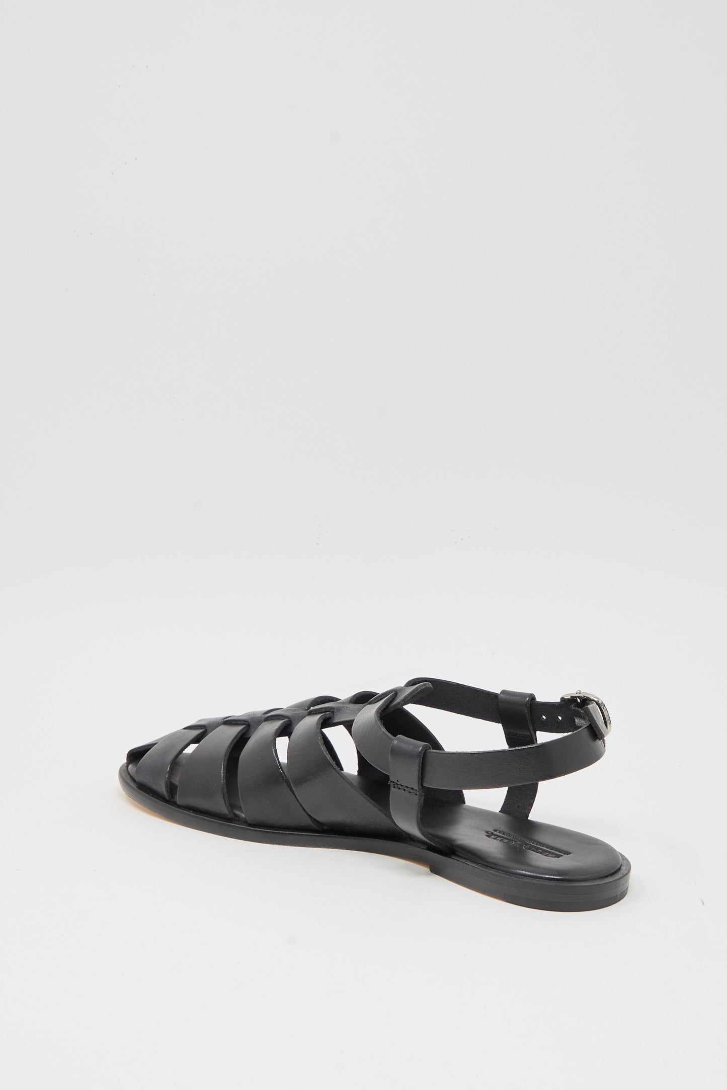 The Dragon Diffusion Pescador Sandal in Black is a handcrafted cow leather fisherman sandal with a closed heel, open toe, and ankle buckle strap, shown against a plain white background.