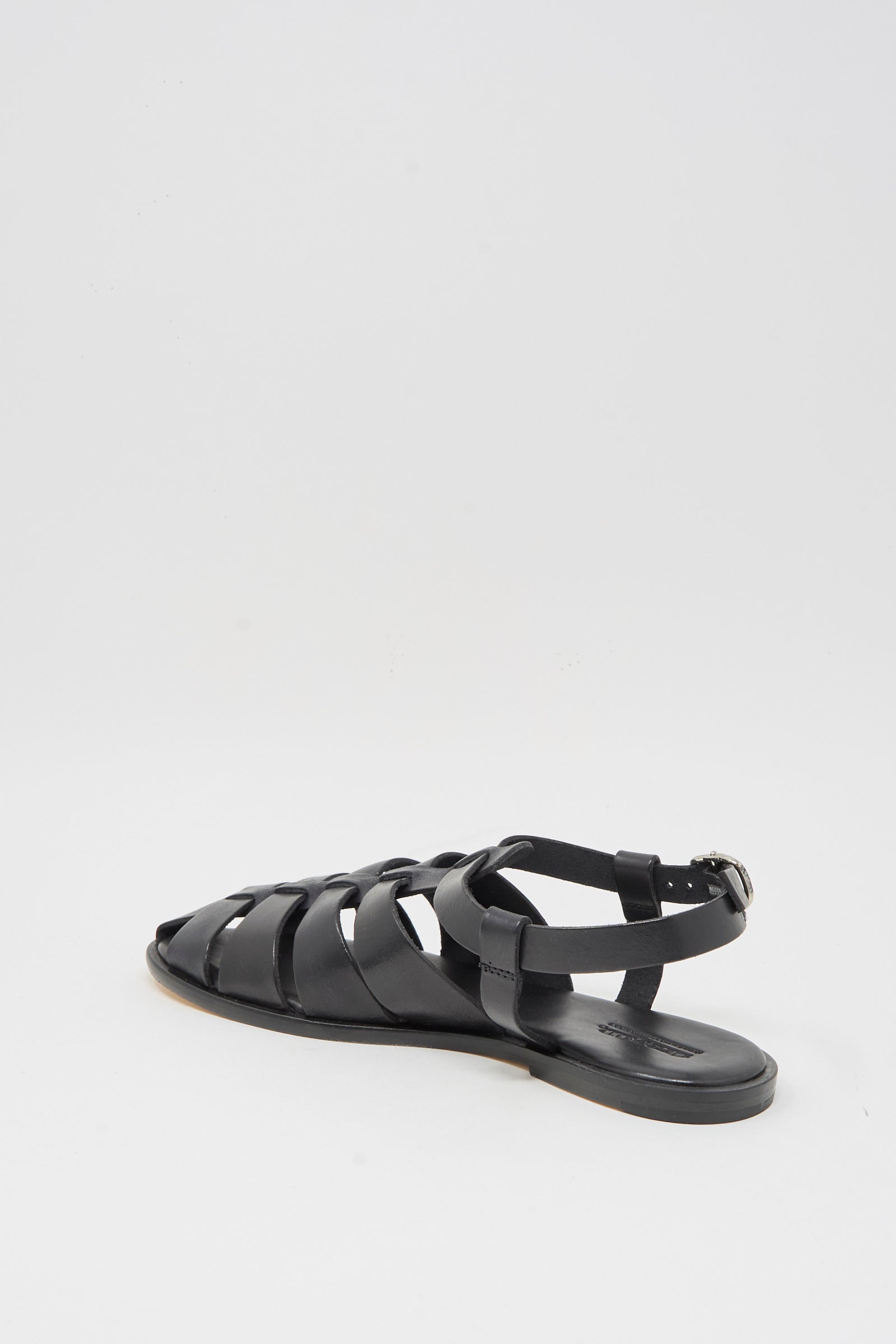 The Dragon Diffusion Pescador Sandal in Black is a handcrafted cow leather fisherman sandal with a closed heel, open toe, and ankle buckle strap, shown against a plain white background.