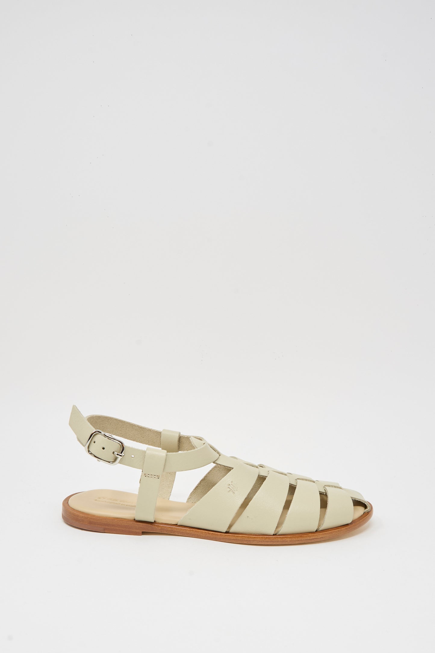 The Dragon Diffusion Pescador Sandal in Pearl is a handcrafted beige cow leather fisherman sandal with multiple straps, open toe, ankle buckle strap, and flat tan sole, shown against a plain white background.