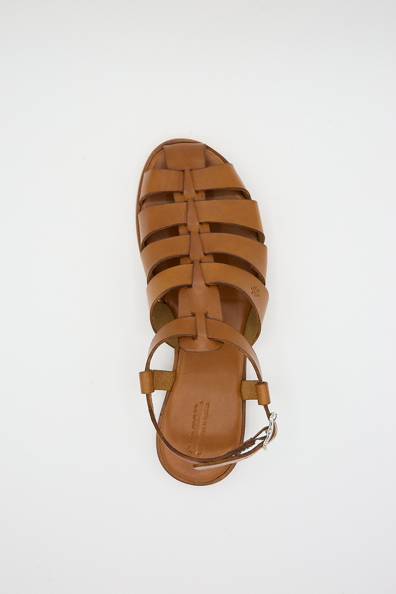 Top view of a single tan Pescador sandal by Dragon Diffusion on a white background.