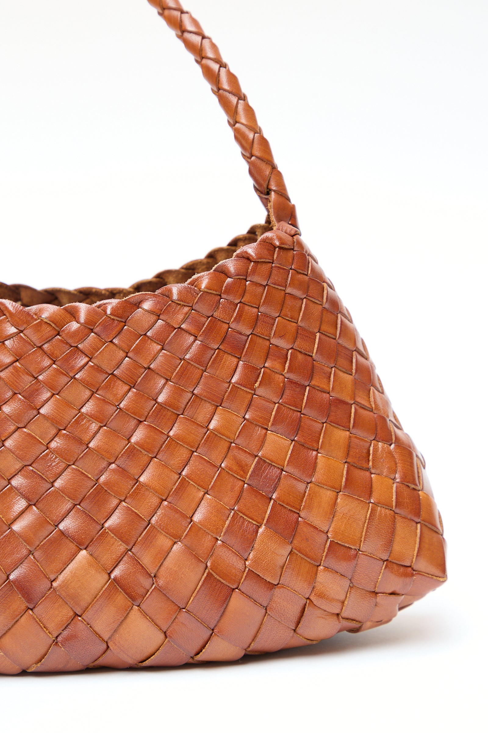 Close-up of a Rosanna in Tan woven buffalo leather handbag by Dragon Diffusion against a white background.