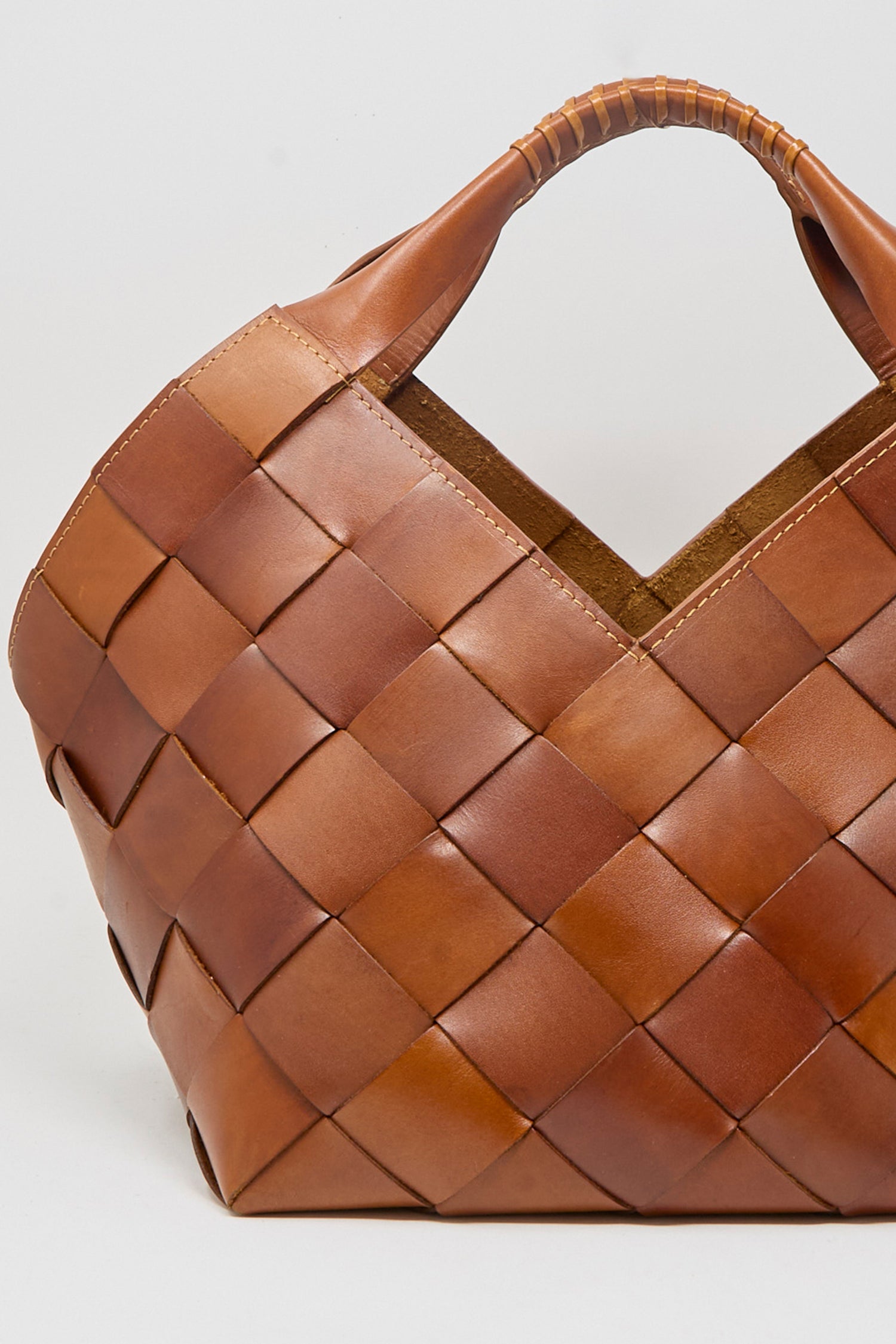 A close up of Dragon Diffusion's Botteghe Bag in tan against a white background.