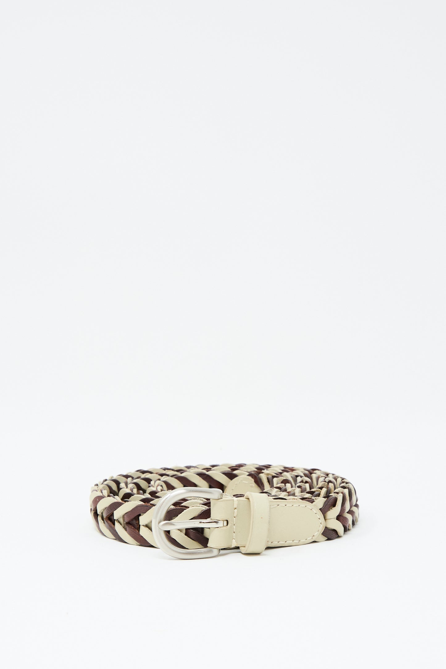 The Dragon Diffusion Single Link Bi-Color Belt in Bruciato and Pearl is a handcrafted braided leather belt with a silver buckle, shown coiled on a plain white background.