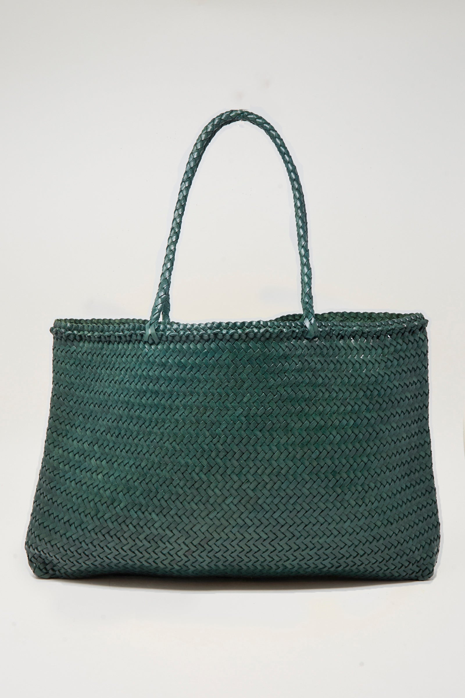 The Sophie Large in Forest by Dragon Diffusion, a green handwoven tote with two handles, is displayed against a plain white background.