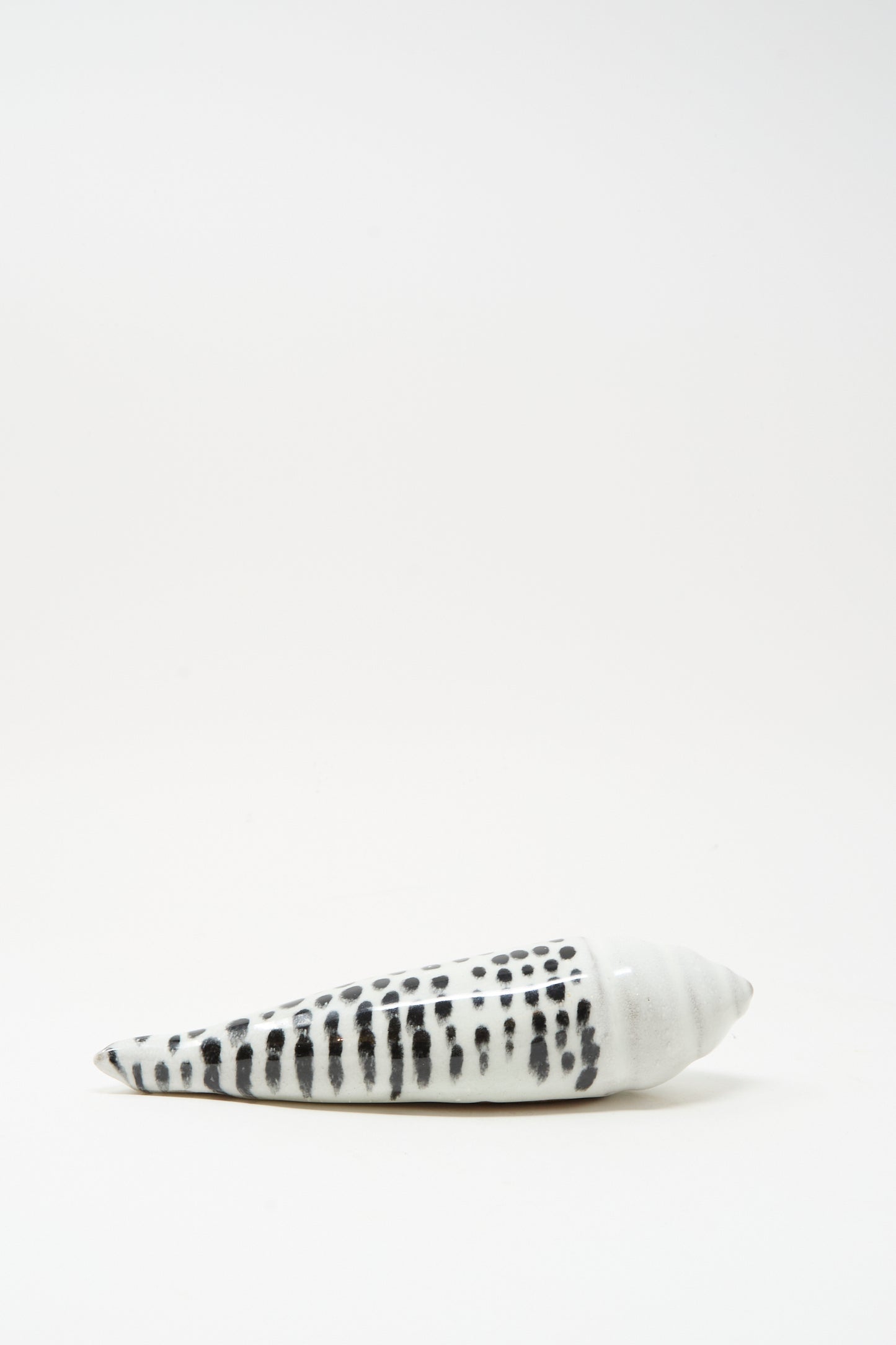 The Shell Rattle XCII by E.C.C.E features a handmade black-and-white ceramic design, crafted in NYC, and is displayed against a plain white background.