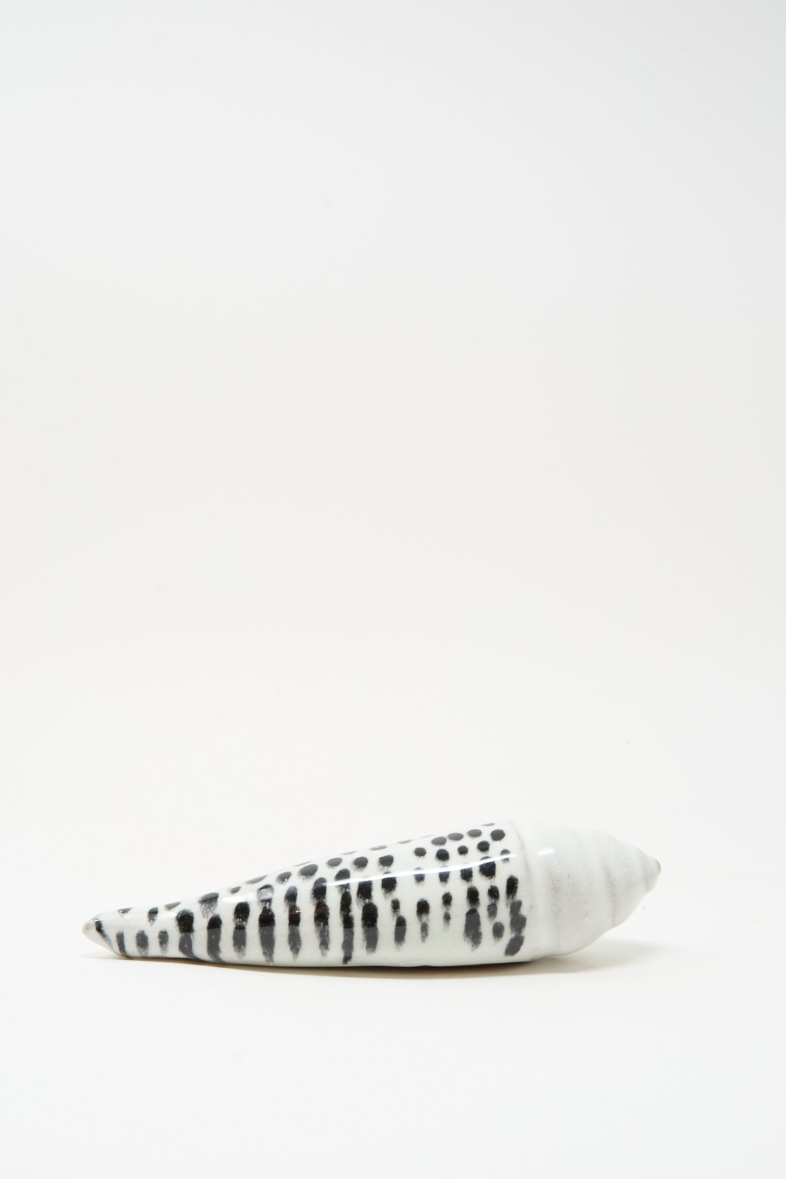 The Shell Rattle XCII by E.C.C.E features a handmade black-and-white ceramic design, crafted in NYC, and is displayed against a plain white background.