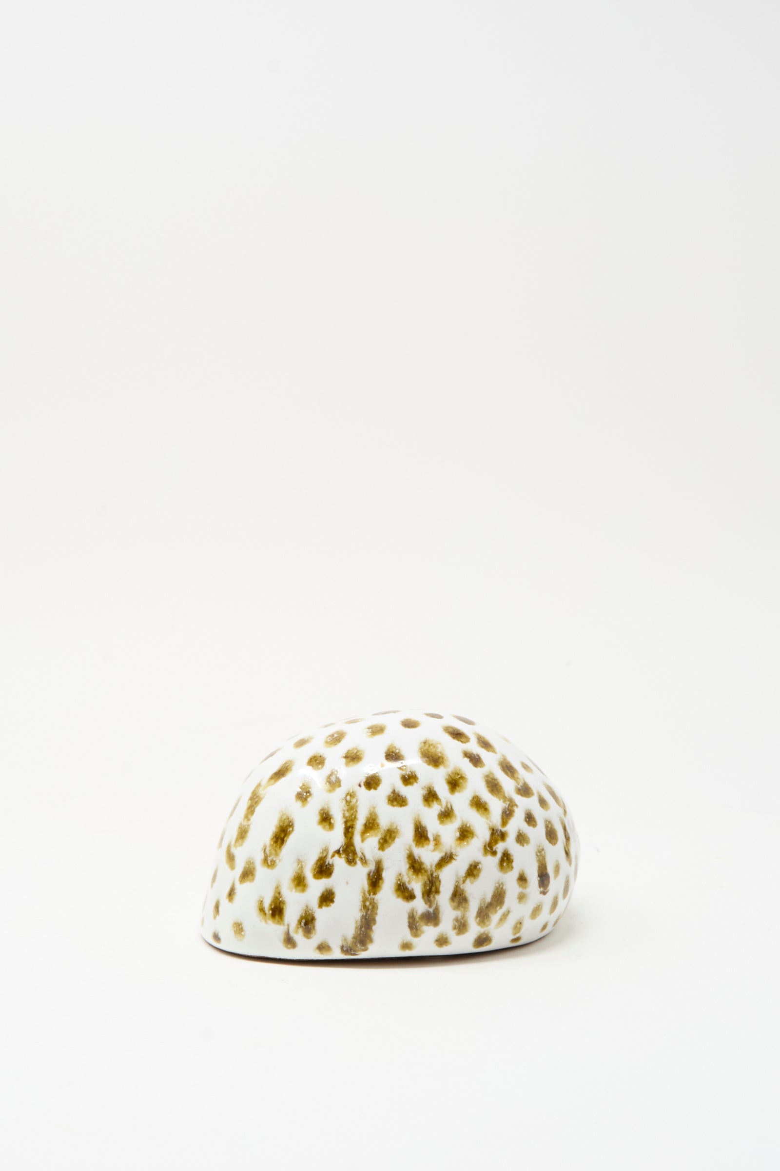 The Shell Rattle XCIV by E.C.C.E is a handmade white ceramic rattle with brown spots, crafted in NYC and displayed on a plain white background.