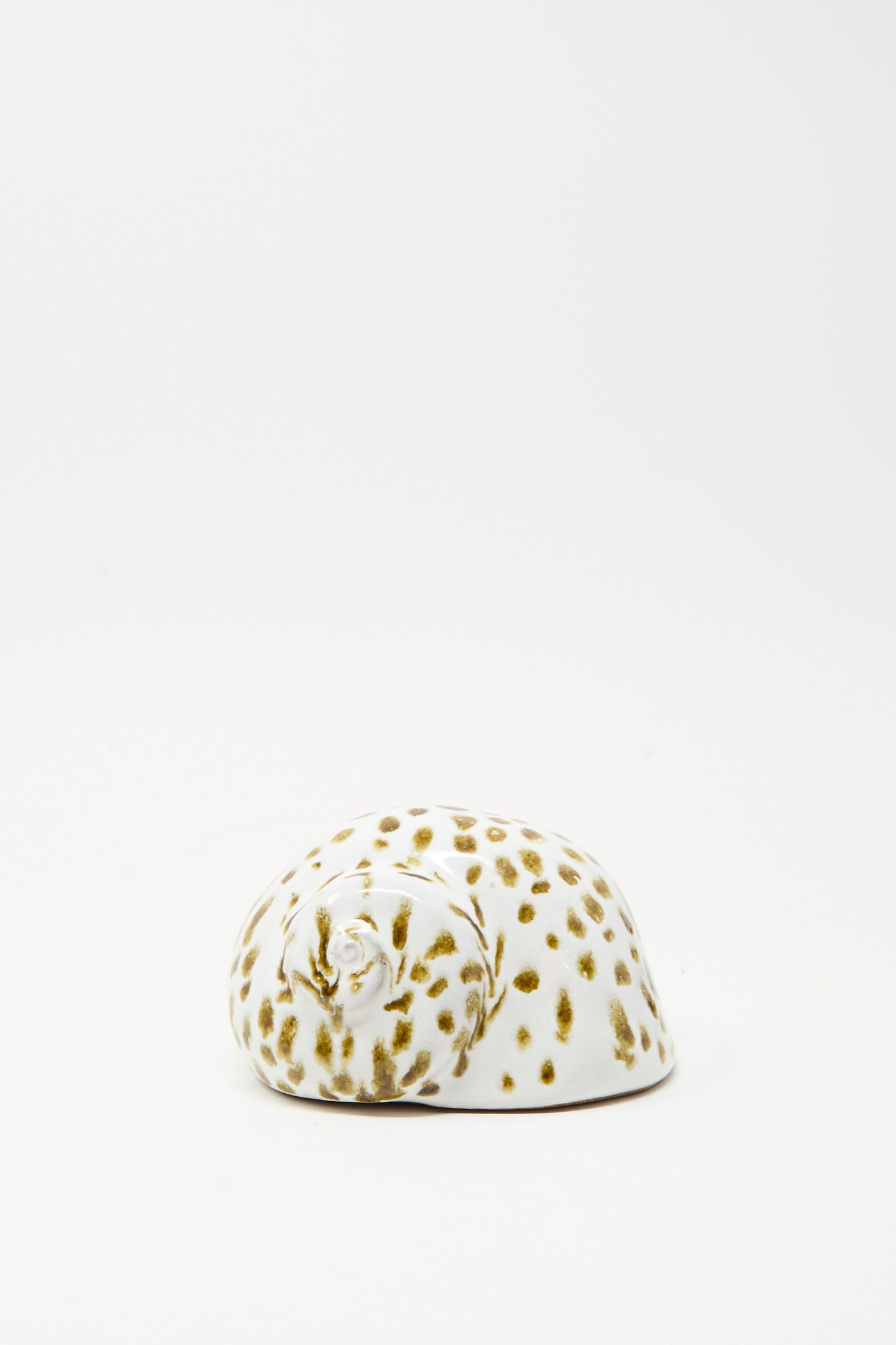 The Shell Rattle XCIV by E.C.C.E, a handmade ceramic piece with brown spots crafted in NYC, is displayed on a plain white background.