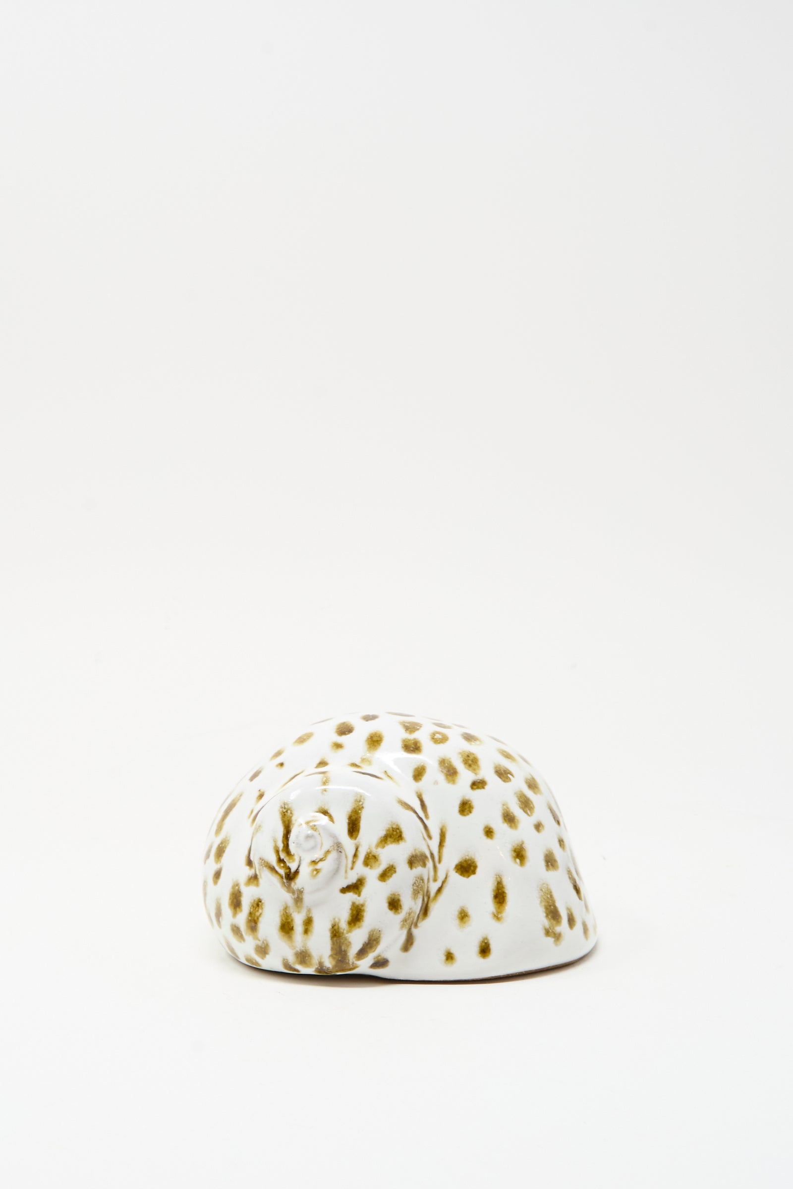 The Shell Rattle XCIV by E.C.C.E, a handmade ceramic piece with brown spots crafted in NYC, is displayed on a plain white background.