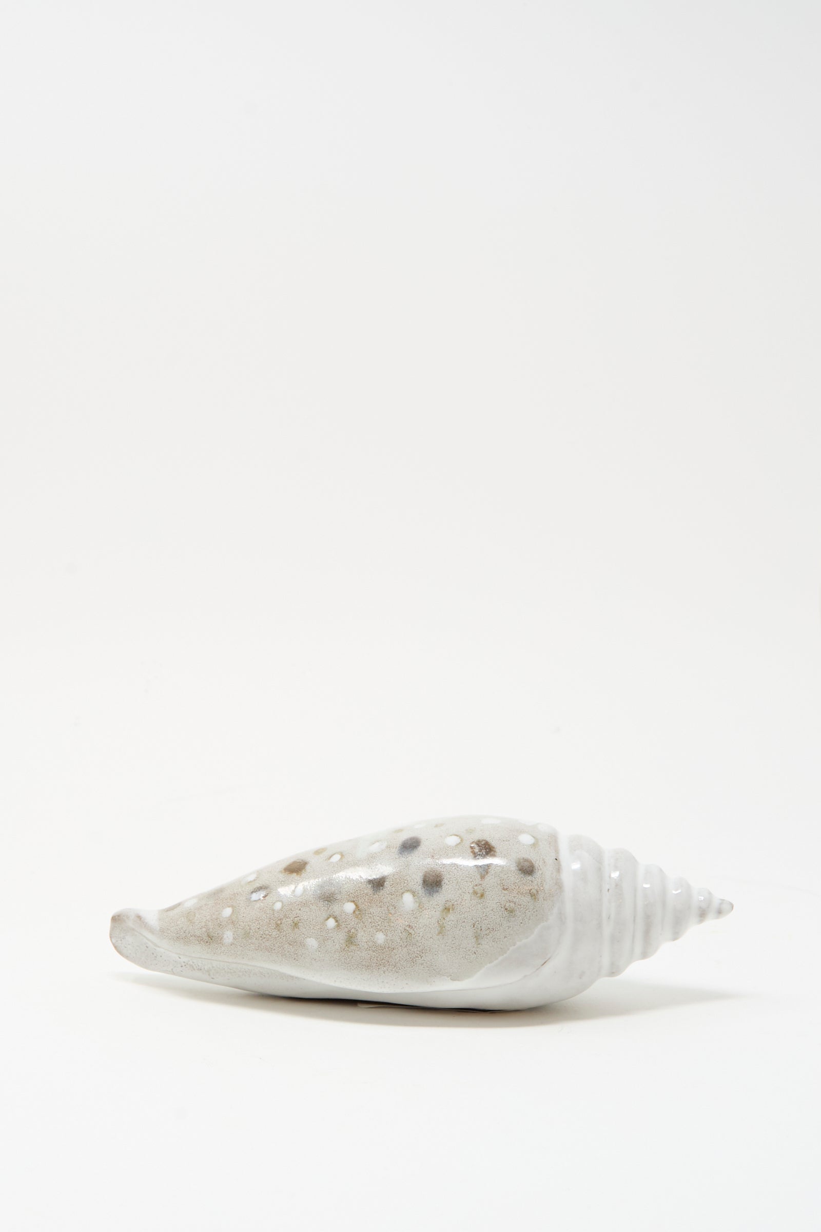 The E.C.C.E Shell Rattle XCV is a handmade conical ceramic shell with brown and white spots, shown against a plain white background.