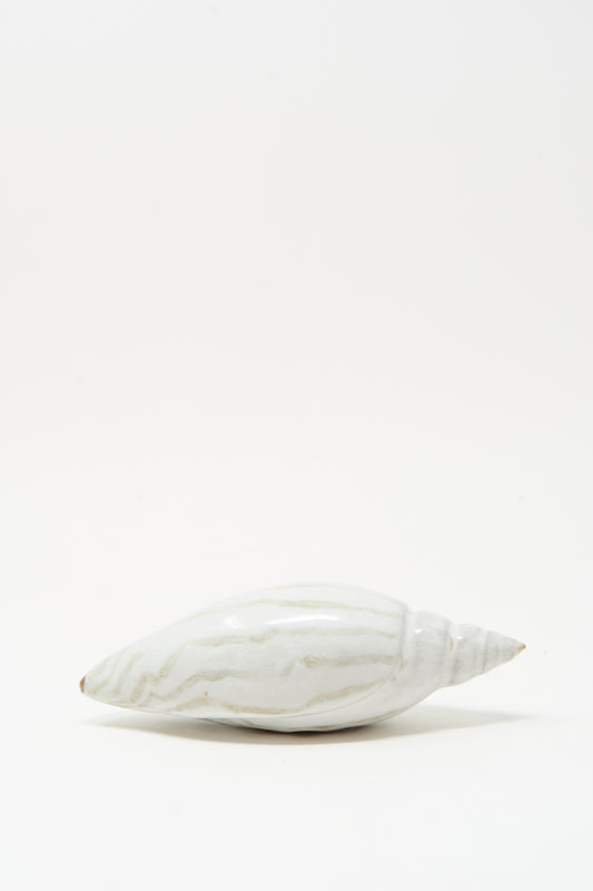 The Shell Rattle LXXVII by E.C.C.E, a handmade ceramic piece with light gray stripes, is displayed on a plain white background.