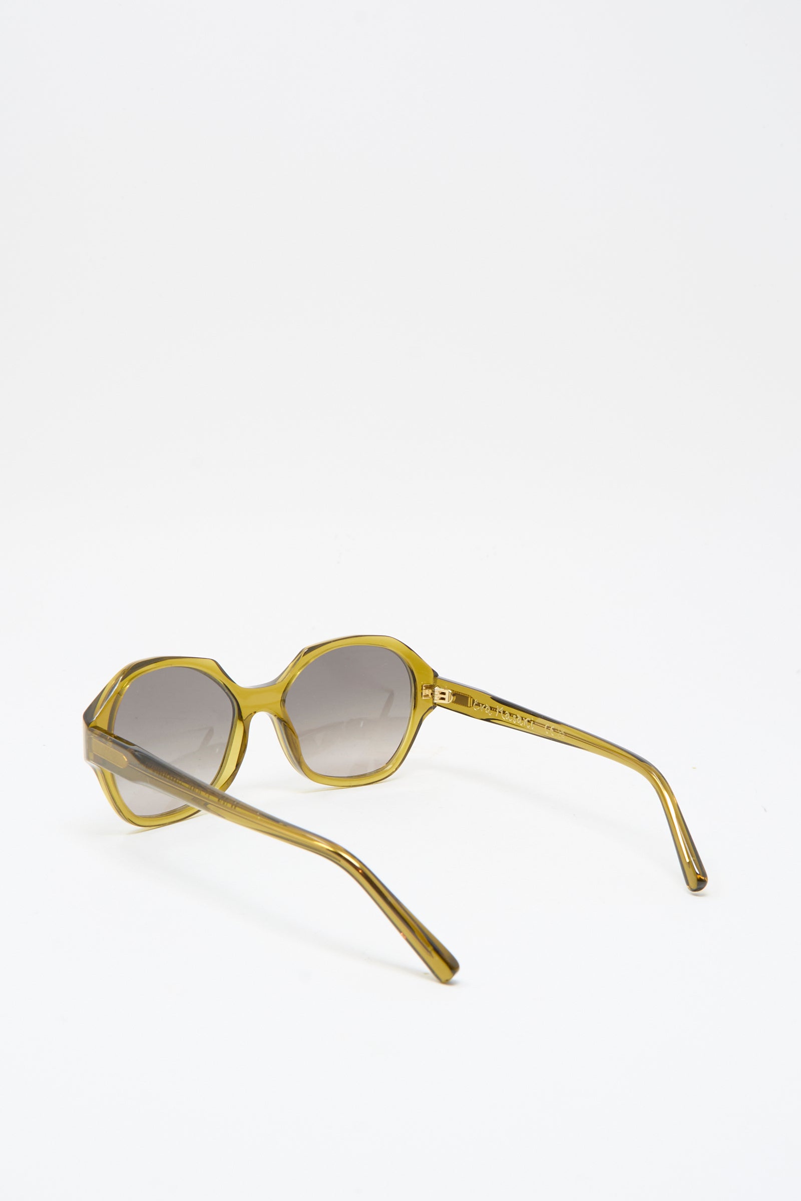 The Eva Masaki 001 Sunglasses in Zumi are round, oversized, yellow-tinted frames with dark lenses, handmade in Italy and displayed on a white background.