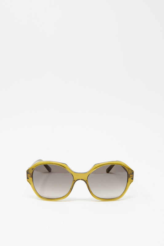 The Eva Masaki 001 Sunglasses in Zumi feature yellow frames and dark tinted lenses, handmade in Italy and shown against a plain white background.