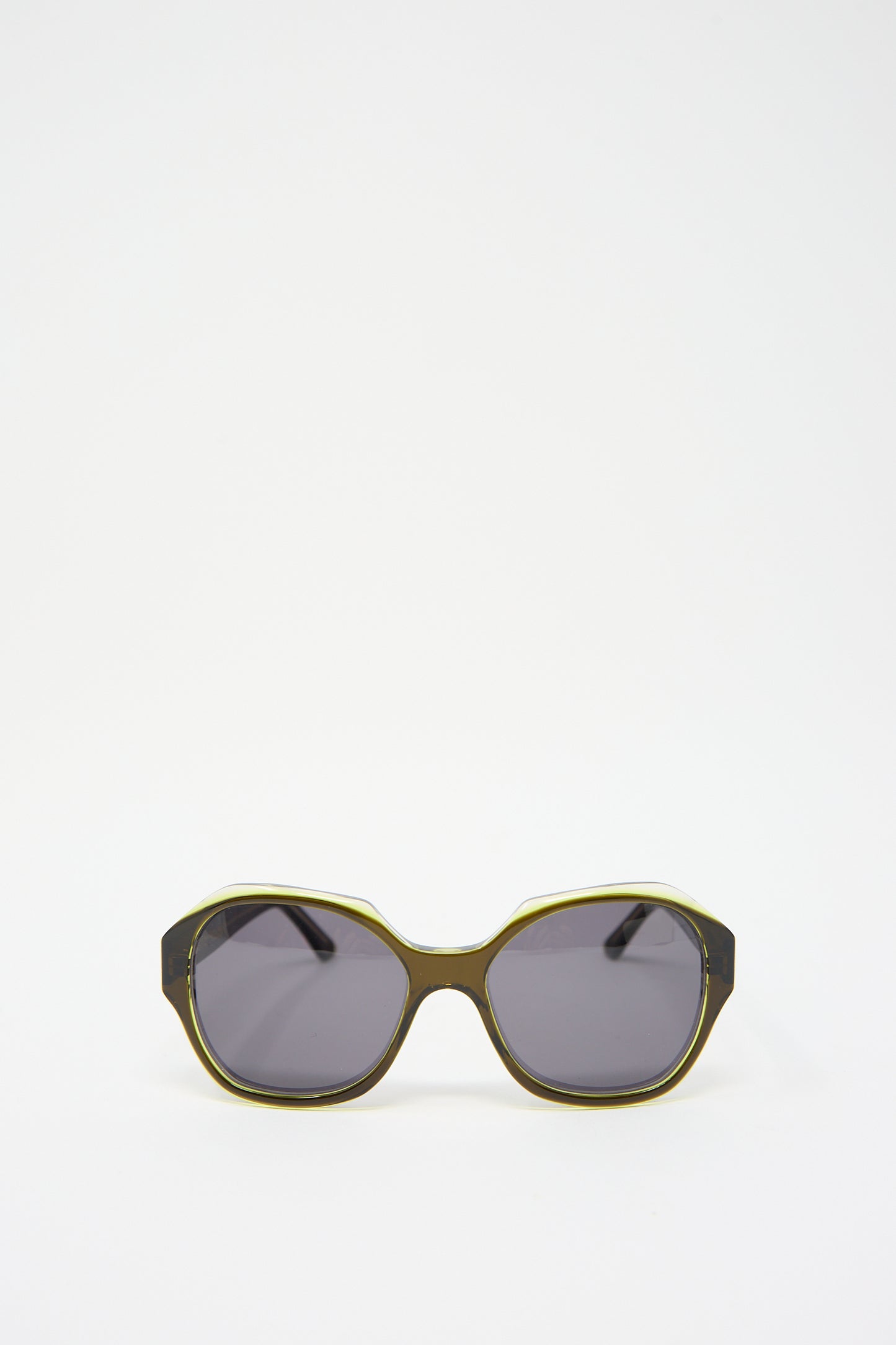 A pair of the Eva Masaki 001 Sunglasses in Greens with dark lenses and a frame in tones of green and black, crafted from durable cellulose acetate, isolated on a white background.