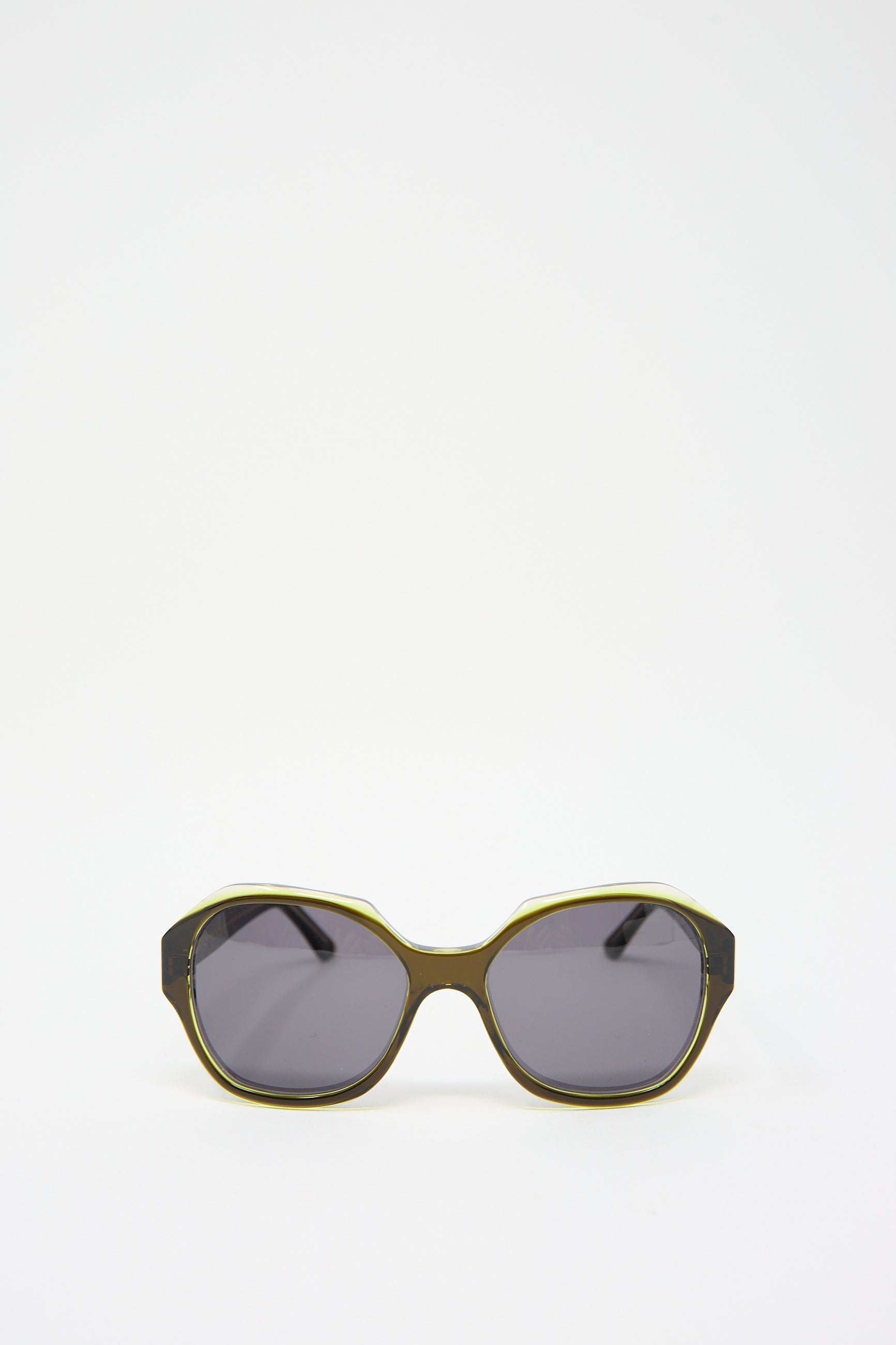 A pair of the Eva Masaki 001 Sunglasses in Greens with dark lenses and a frame in tones of green and black, crafted from durable cellulose acetate, isolated on a white background.