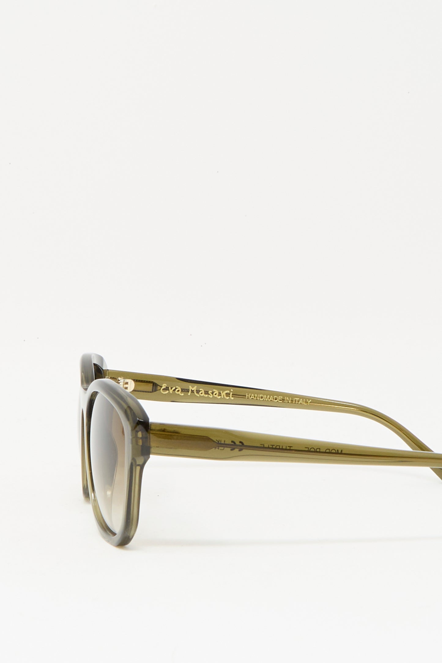 The Eva Masaki BQE Sunglasses in Turtle feature round Zeiss lenses, translucent Mazzucchelli acetate frames, and inner arm gold text that reads "HANDMADE IN ITALY.