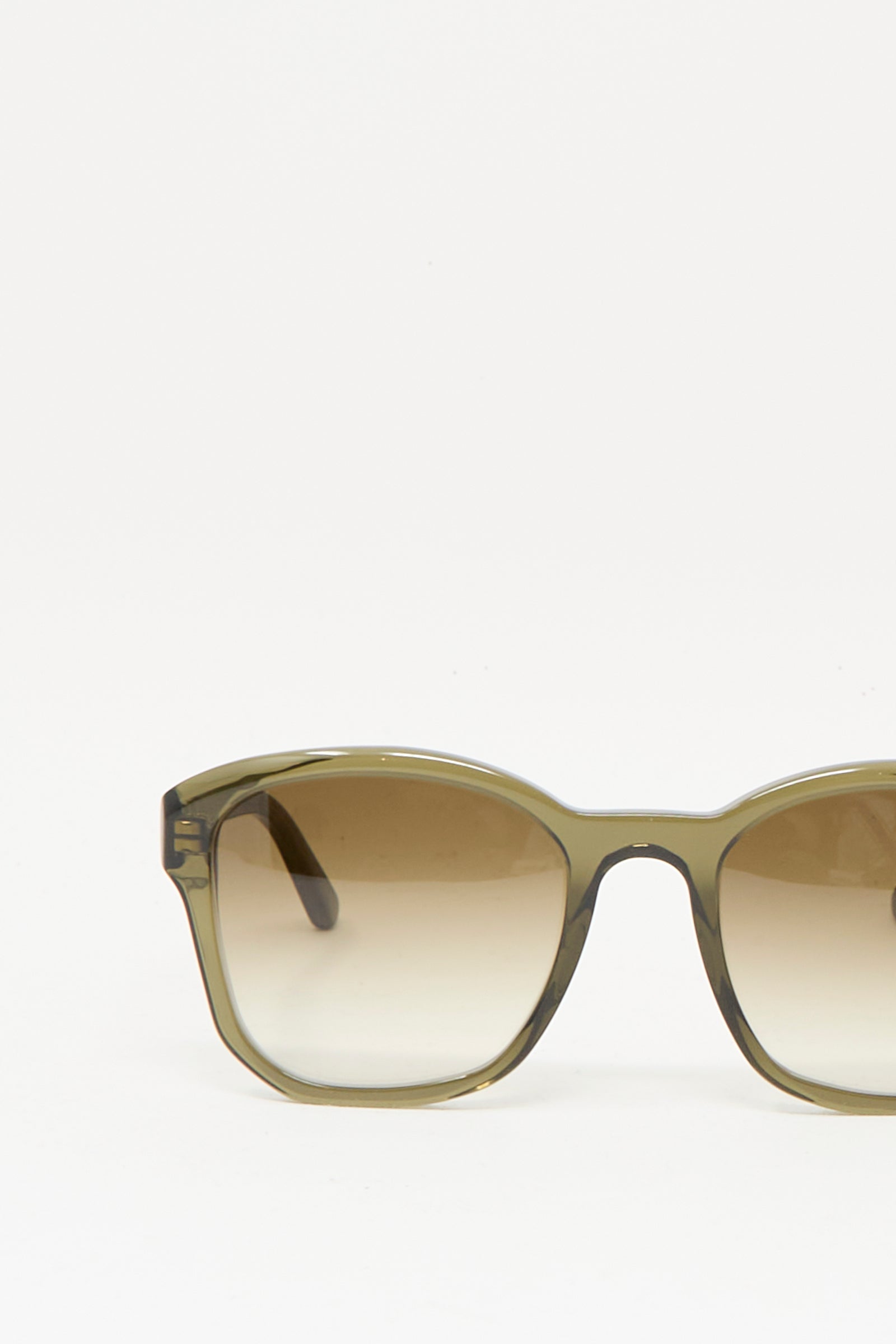 Close-up of the right half of Eva Masaki BQE Sunglasses in Turtle, featuring a greenish-brown gradient Mazzucchelli acetate frame, set against a plain white background.