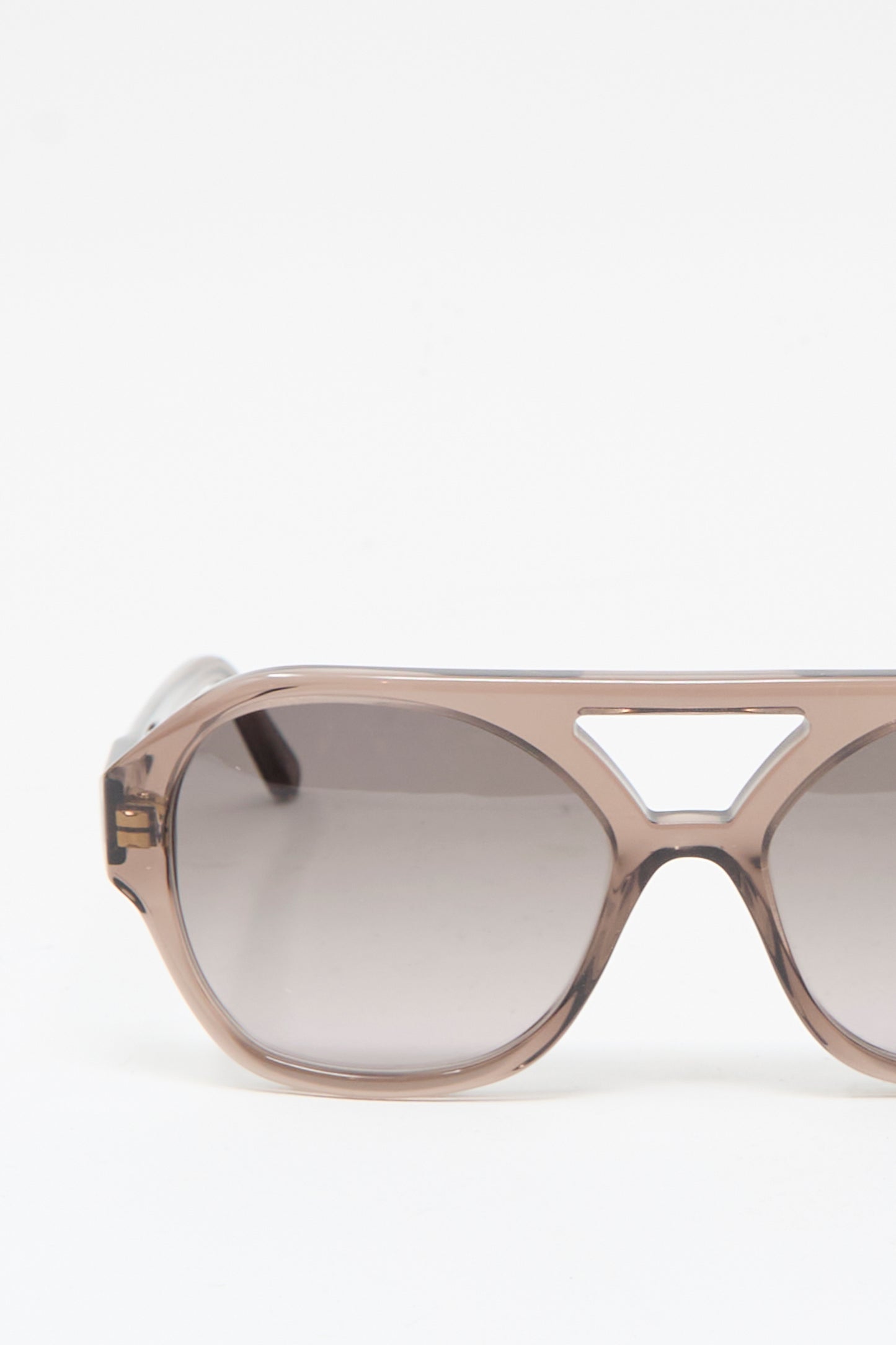 Close-up of Eva Masaki's Chiyo Aviator Sunglasses in Bambi, crafted from brown Italian acetate with a geometric bridge cutout, set against a plain white background.