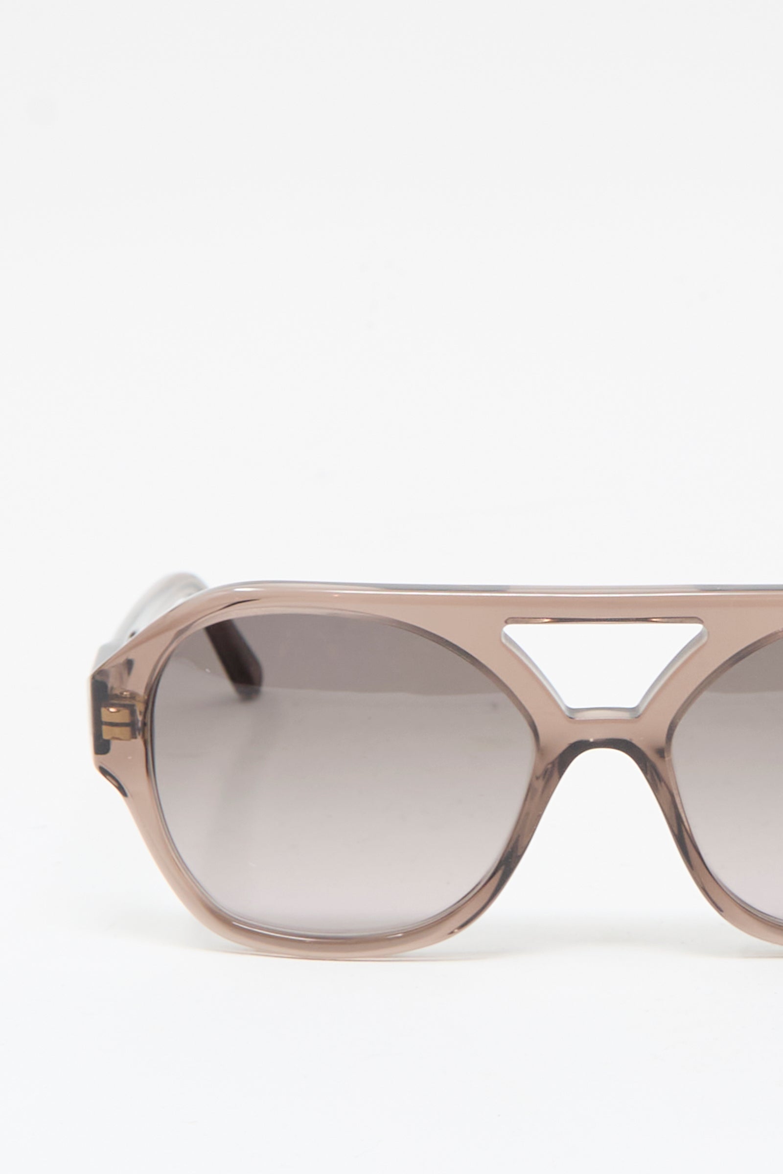 Close-up of Eva Masaki's Chiyo Aviator Sunglasses in Bambi, crafted from brown Italian acetate with a geometric bridge cutout, set against a plain white background.