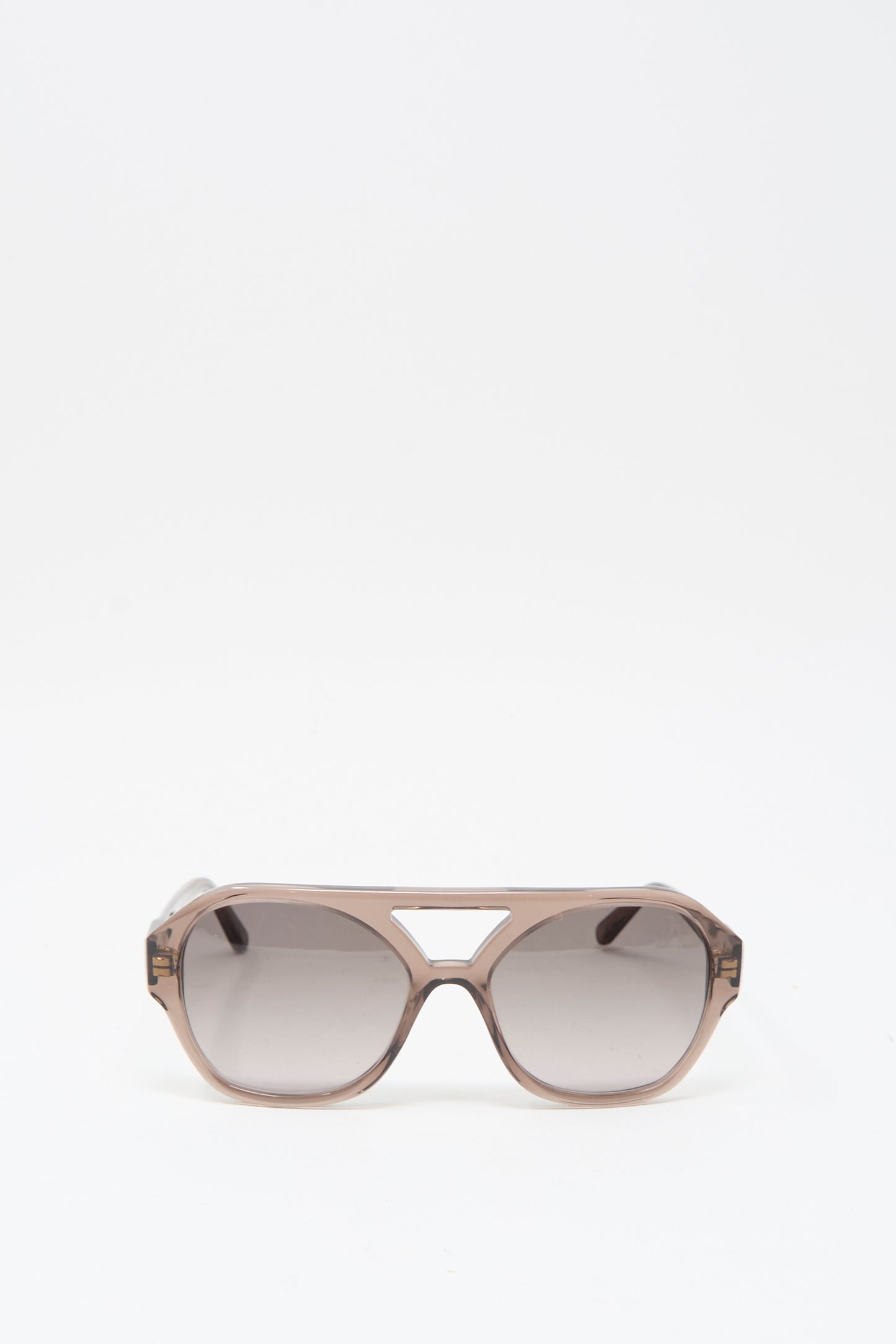 The Eva Masaki Chiyo Aviator Sunglasses in Bambi feature brown-tinted oversized lenses and a geometric cutout above the nose bridge, crafted from Italian acetate and shown on a plain white background.
