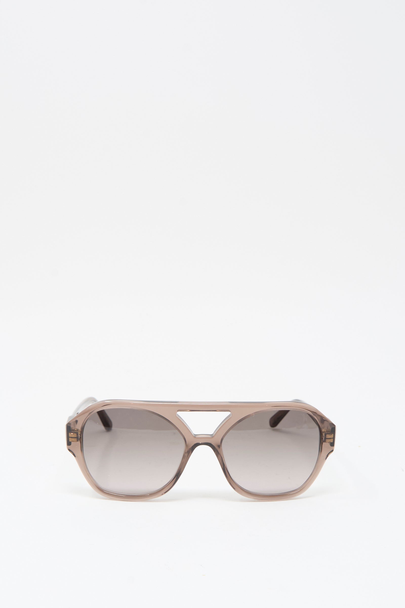 The Eva Masaki Chiyo Aviator Sunglasses in Bambi feature brown-tinted oversized lenses and a geometric cutout above the nose bridge, crafted from Italian acetate and shown on a plain white background.