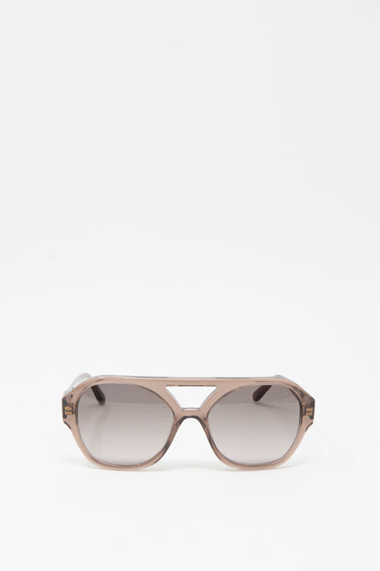 The Eva Masaki Chiyo Aviator Sunglasses in Bambi feature brown-tinted oversized lenses and a geometric cutout above the nose bridge, crafted from Italian acetate and shown on a plain white background.