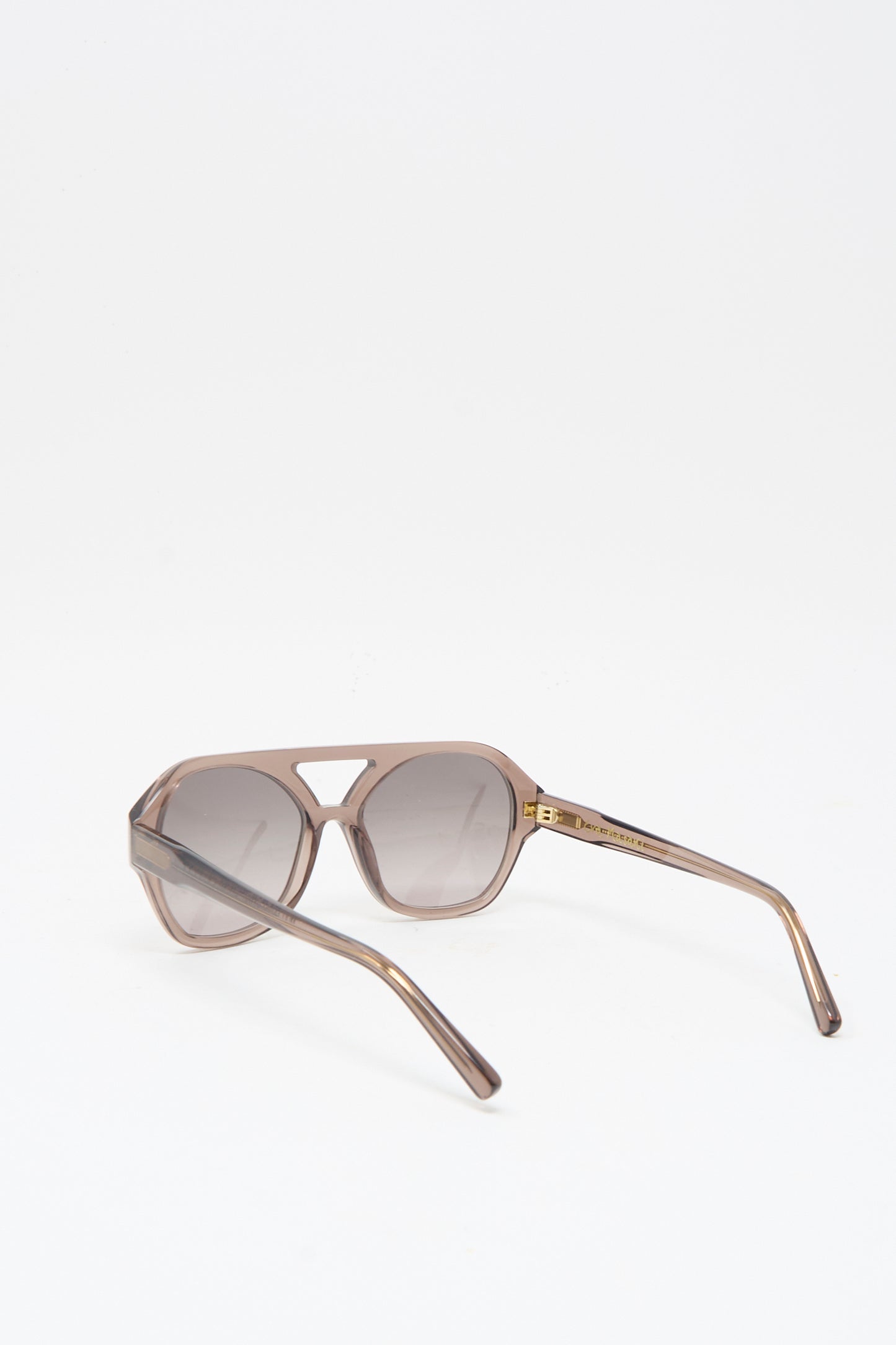 The Eva Masaki Chiyo Aviator Sunglasses in Bambi feature geometric frames crafted from Italian acetate, tinted lenses, and a handmade brown finish, shown on a white background.