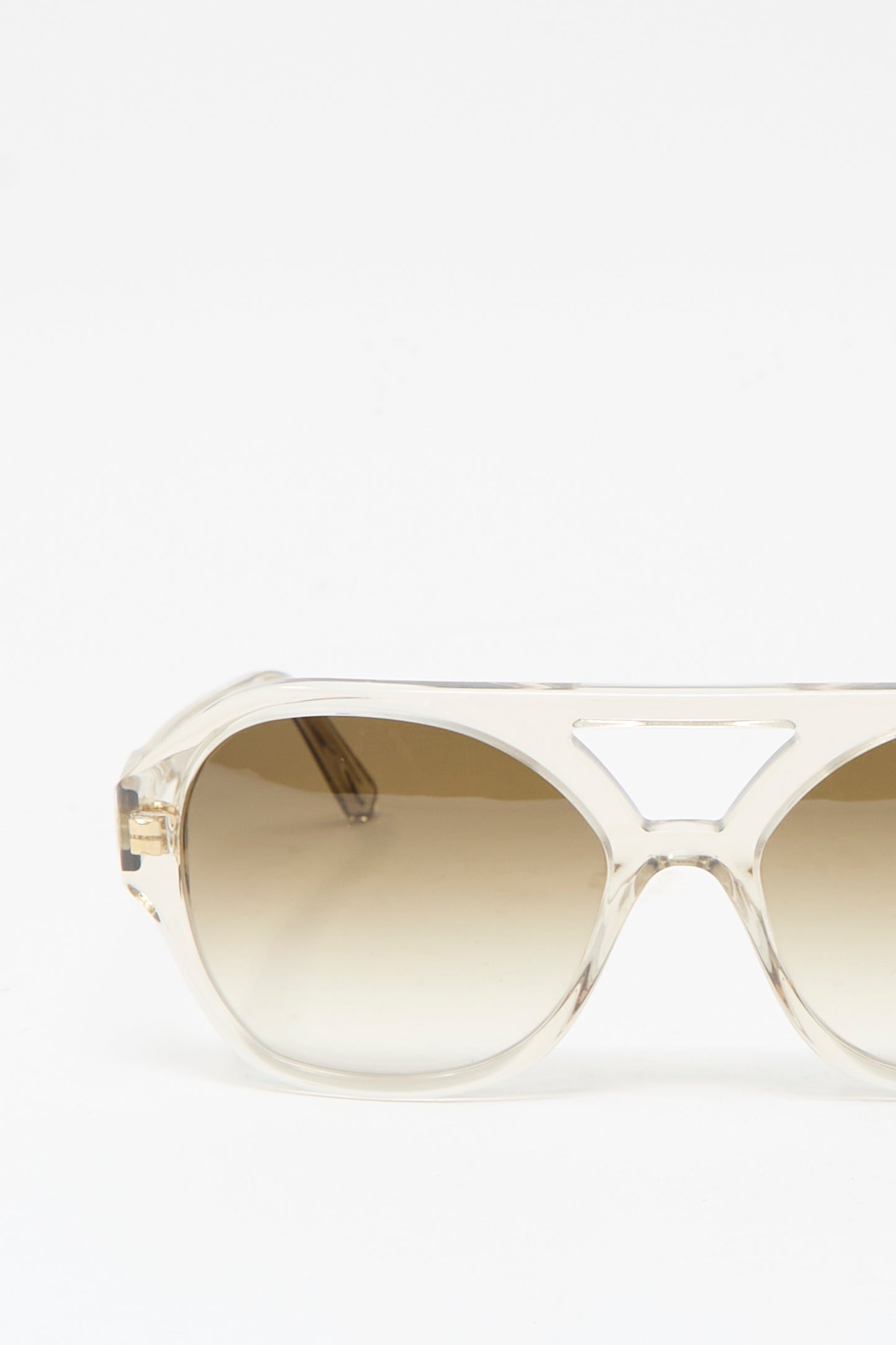 The Eva Masaki Chiyo Aviator Sunglasses in Hinoki feature clear acrylic frames and brown gradient lenses with UV protection, shown from the front on a plain white background.
