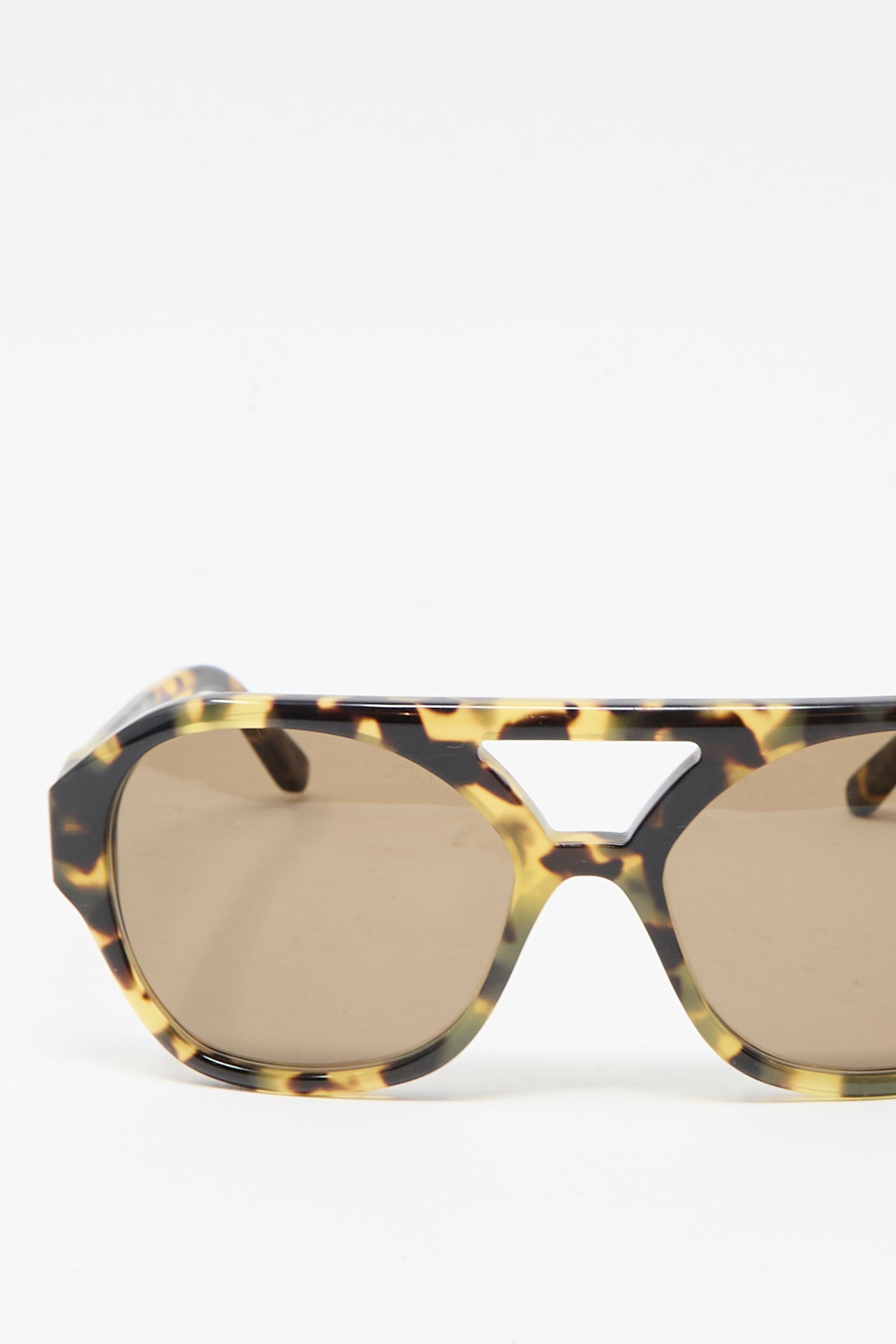 The Chiyo Aviator Sunglasses in Tokyo by Eva Masaki feature a geometric tortoiseshell Italian acetate frame, brown lenses with UV protection, and a cut-out above the nose bridge. Displayed on a plain white background.