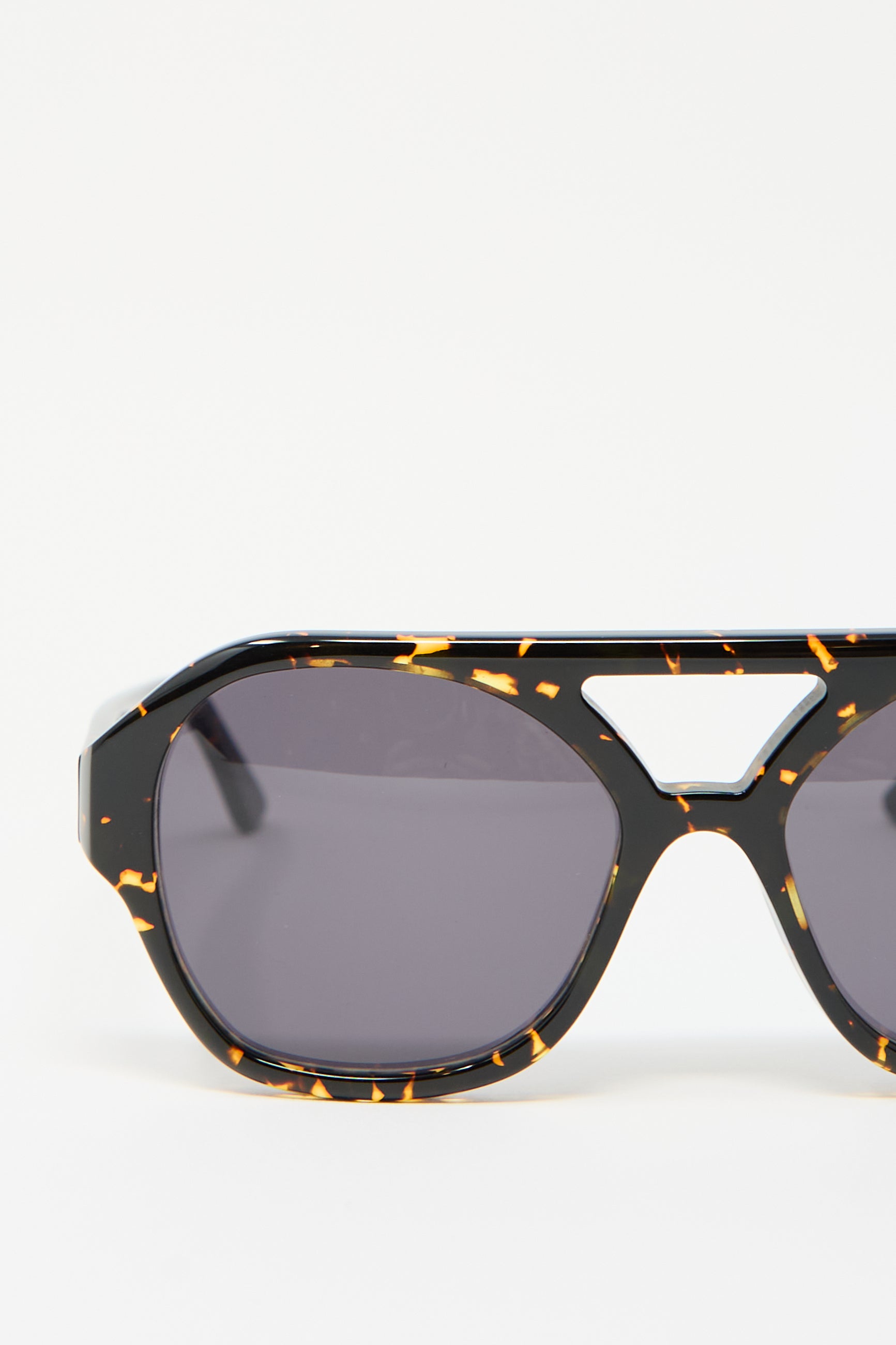 Close-up of the Chiyo Aviator Sunglasses in Gotham by Eva Masaki, featuring black aviator frames with a gold speckled pattern, crafted from premium Italian acetate.