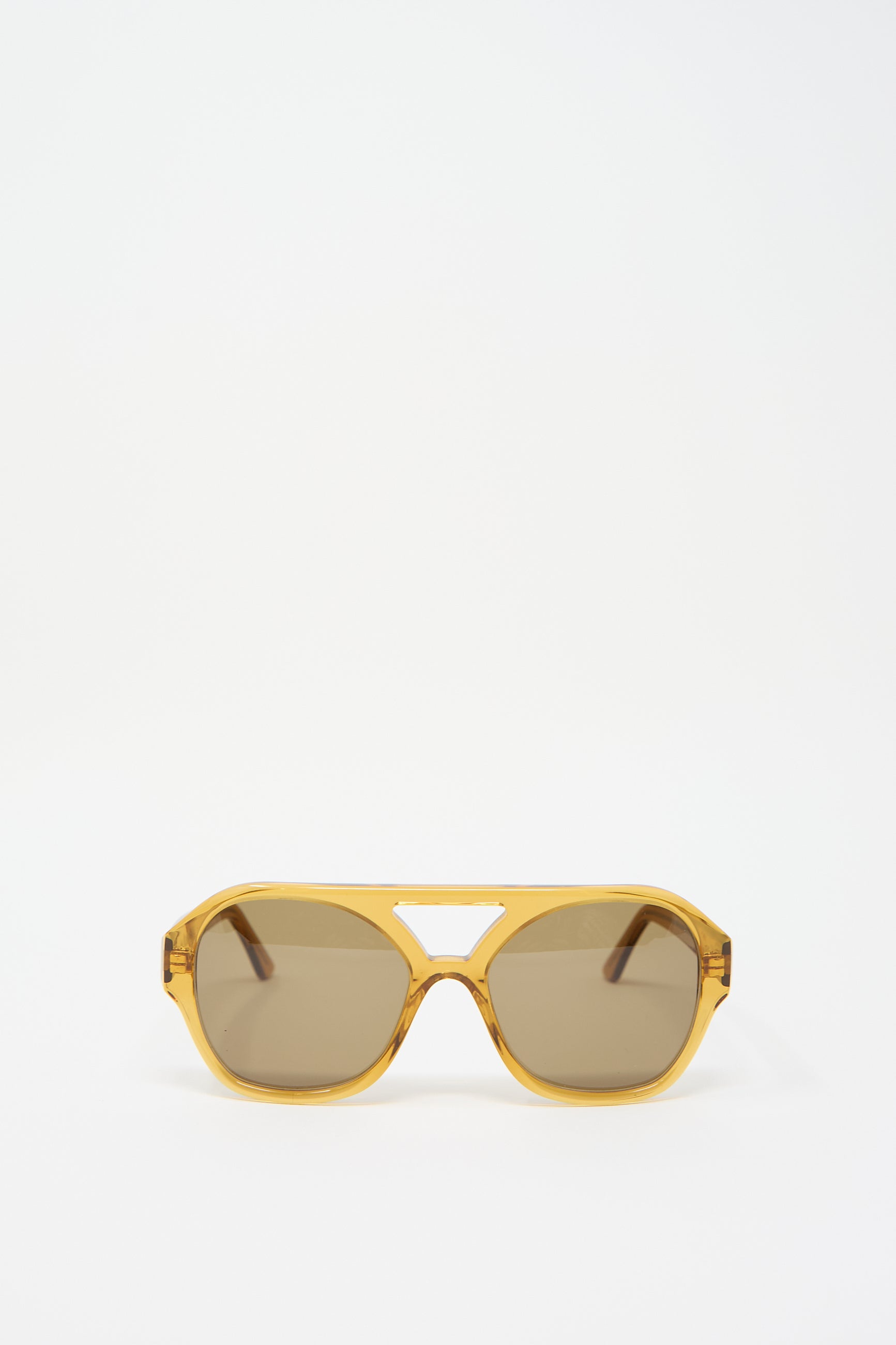 A pair of Chiyo Aviator Sunglasses in Honey by Eva Masaki, crafted from Italian acetate, displayed against a plain white background.