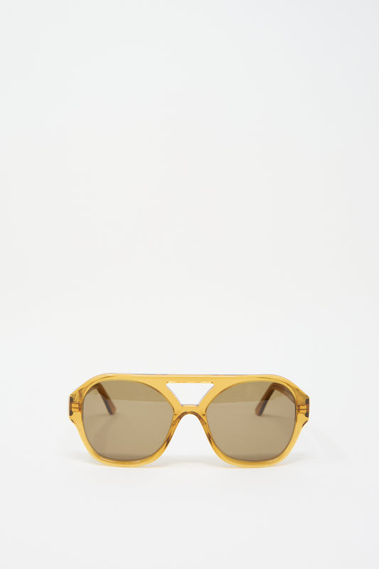 A pair of Chiyo Aviator Sunglasses in Honey by Eva Masaki, crafted from Italian acetate, displayed against a plain white background.