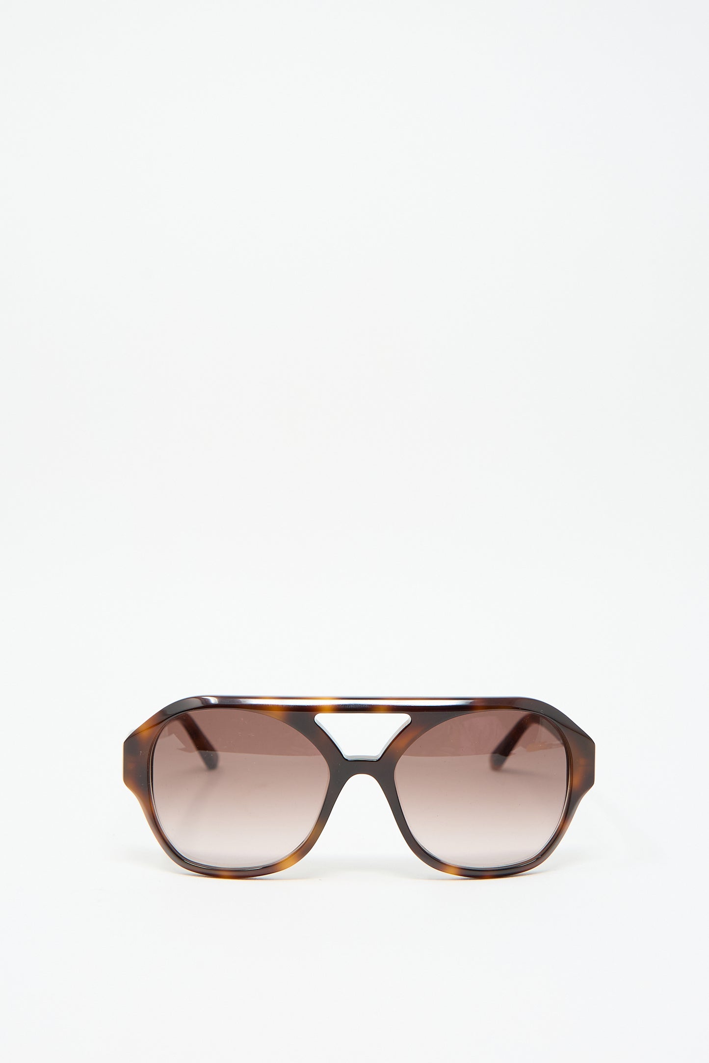 Chiyo Sunglasses in Good Luck by Eva Masaki, crafted from Italian acetate with a tortoiseshell design and complemented by brown gradient lenses, showcased on a plain white background.