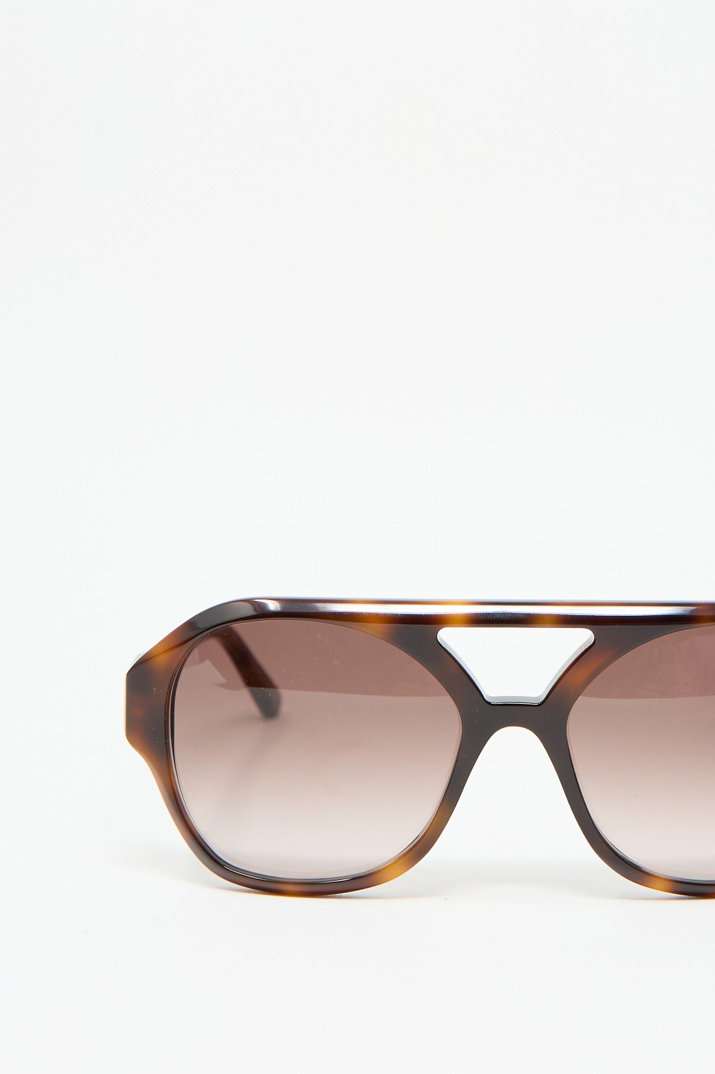 Close-up of the Chiyo Sunglasses in Good Luck by Eva Masaki, featuring a tortoiseshell frame expertly crafted from Italian acetate and tinted lenses, providing stylish UV protection, set against a plain white background.