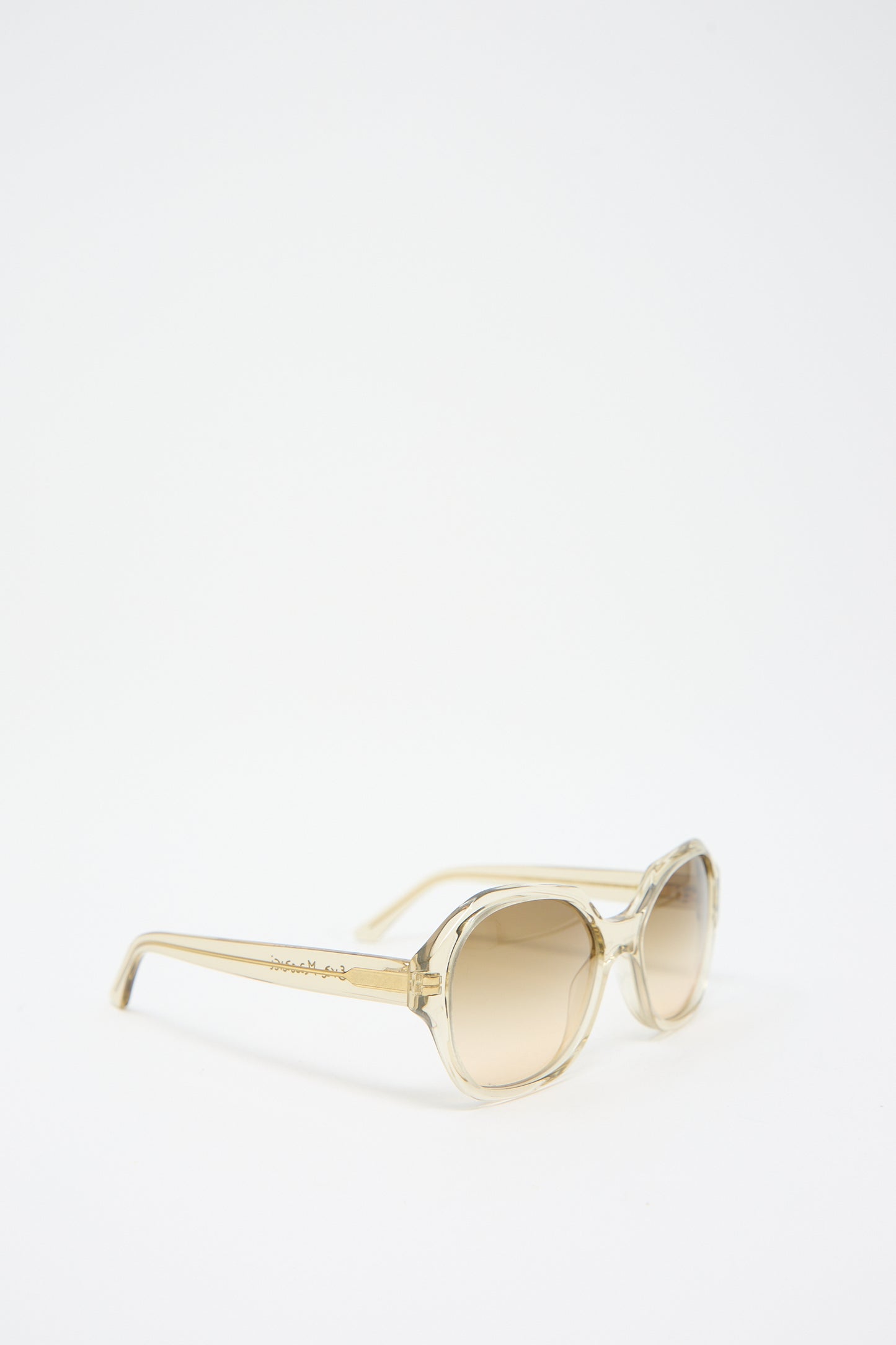 A pair of Eva Masaki 001 Sunglasses in Toast with a beige oversized hexagonal frame and tinted Zeiss lenses placed on a white background.