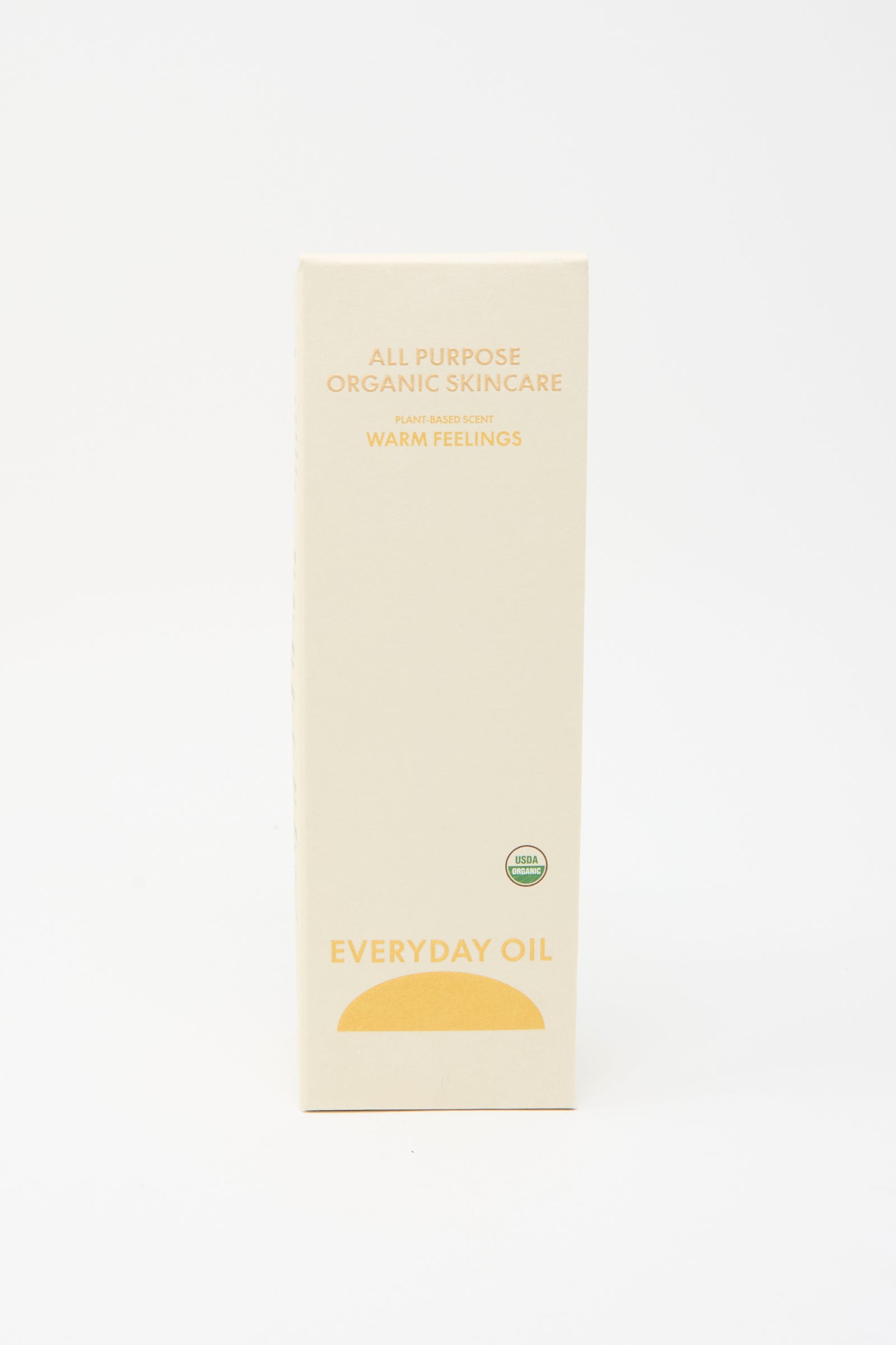 A beige rectangular box labeled "Everyday Oil Warm Feelings - 8 Ounces," an all-natural, plant-based moisturizer, stands upright against a plain white background.
